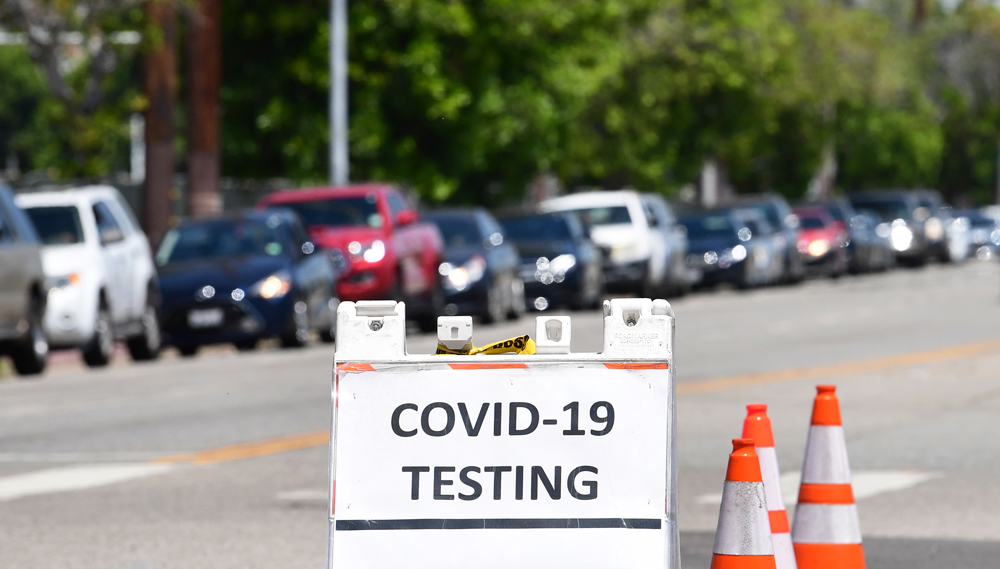 Drivers in their vehicles wait in a long line at a coronavirus testing site in Los Angeles, California on June 10.