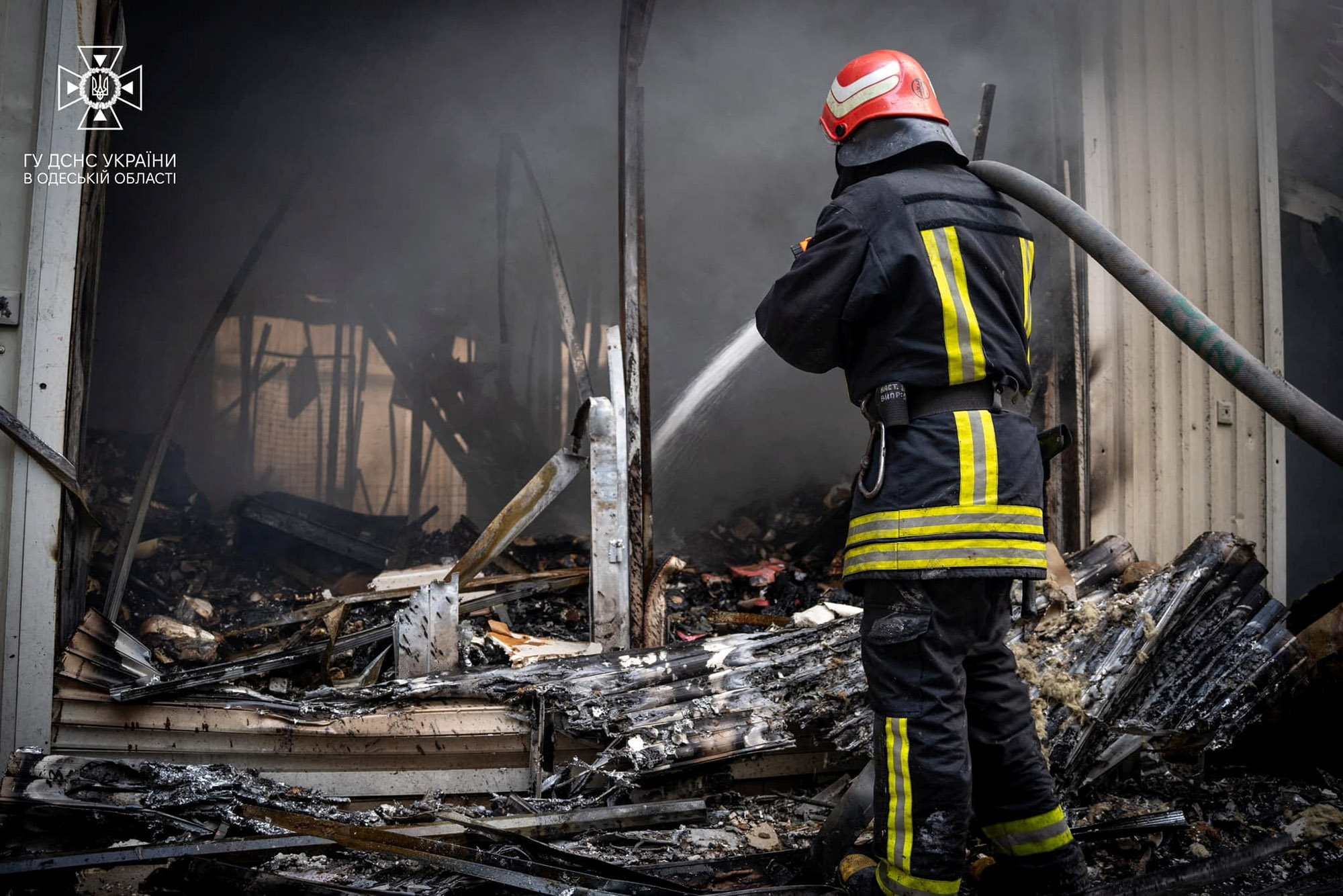 A firefighter works at the site of a storage facility hit during Russian missile and drone strikes in Odesa, Ukraine, on July 19. 