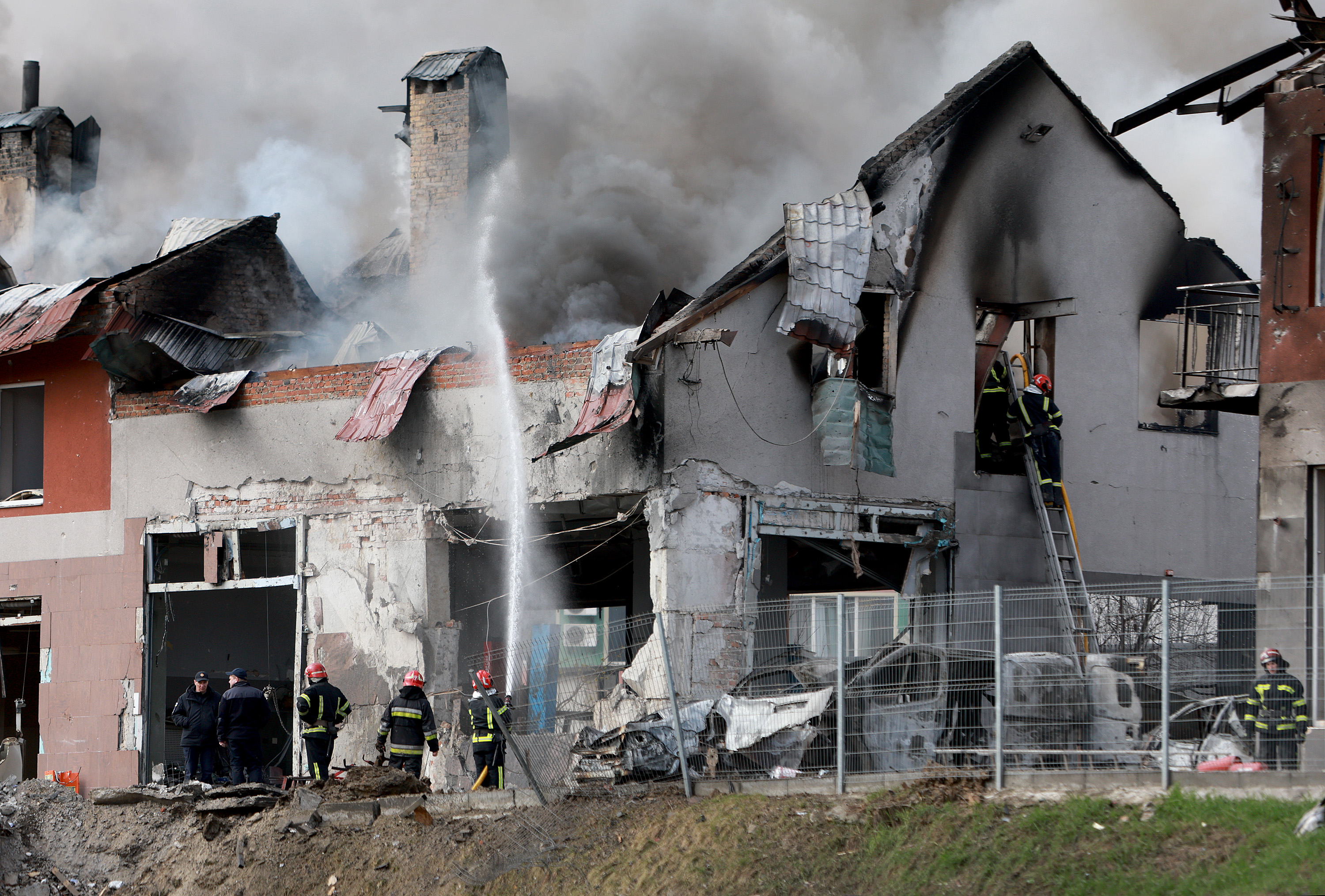 Firefighters battle a blaze after a civilian building was hit by a Russian missile on April 18, in Lviv, Ukraine.