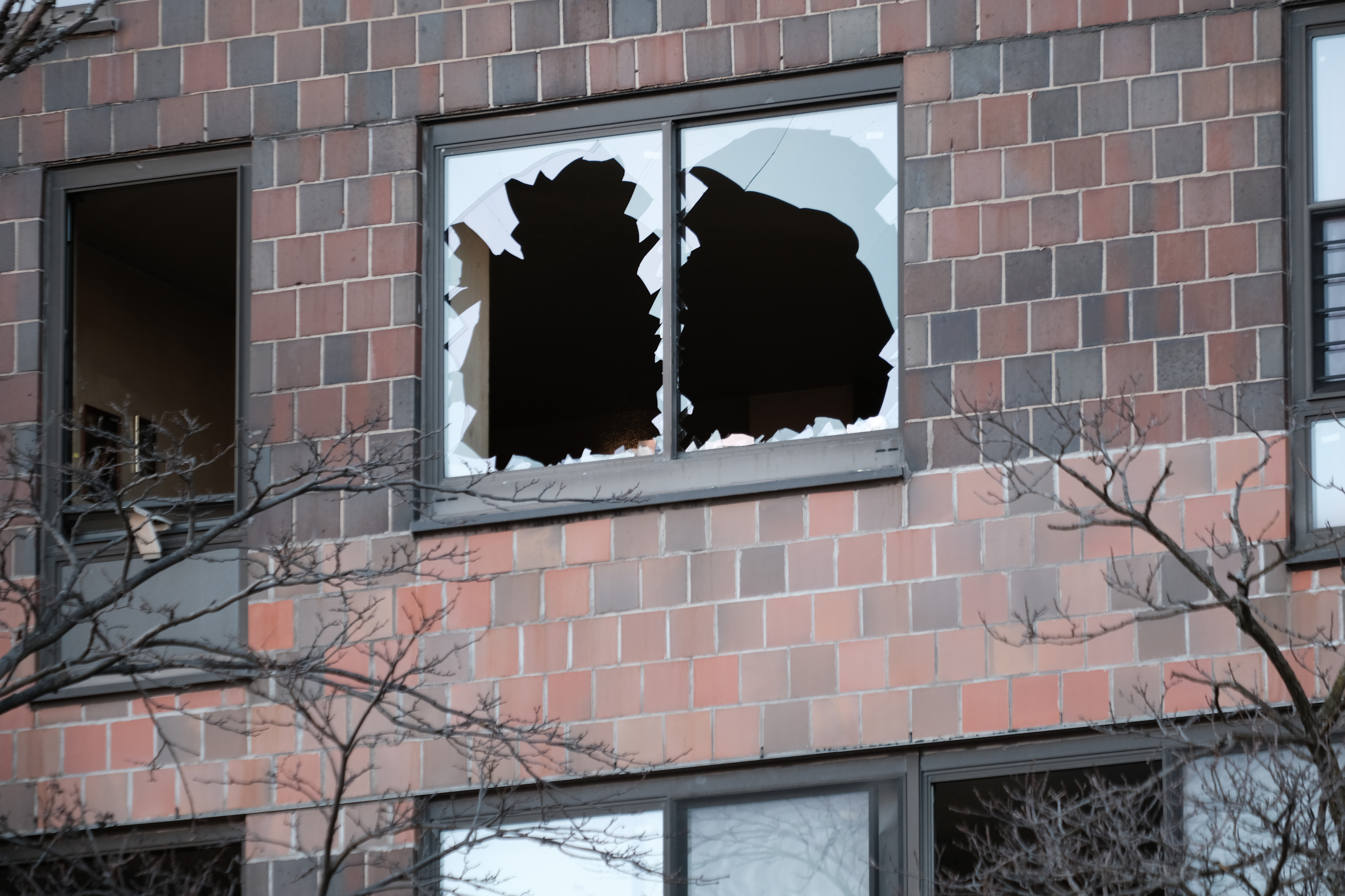 Broken windows are seen at a Bronx apartment building a day after a deadly fire swept through on Sunday.