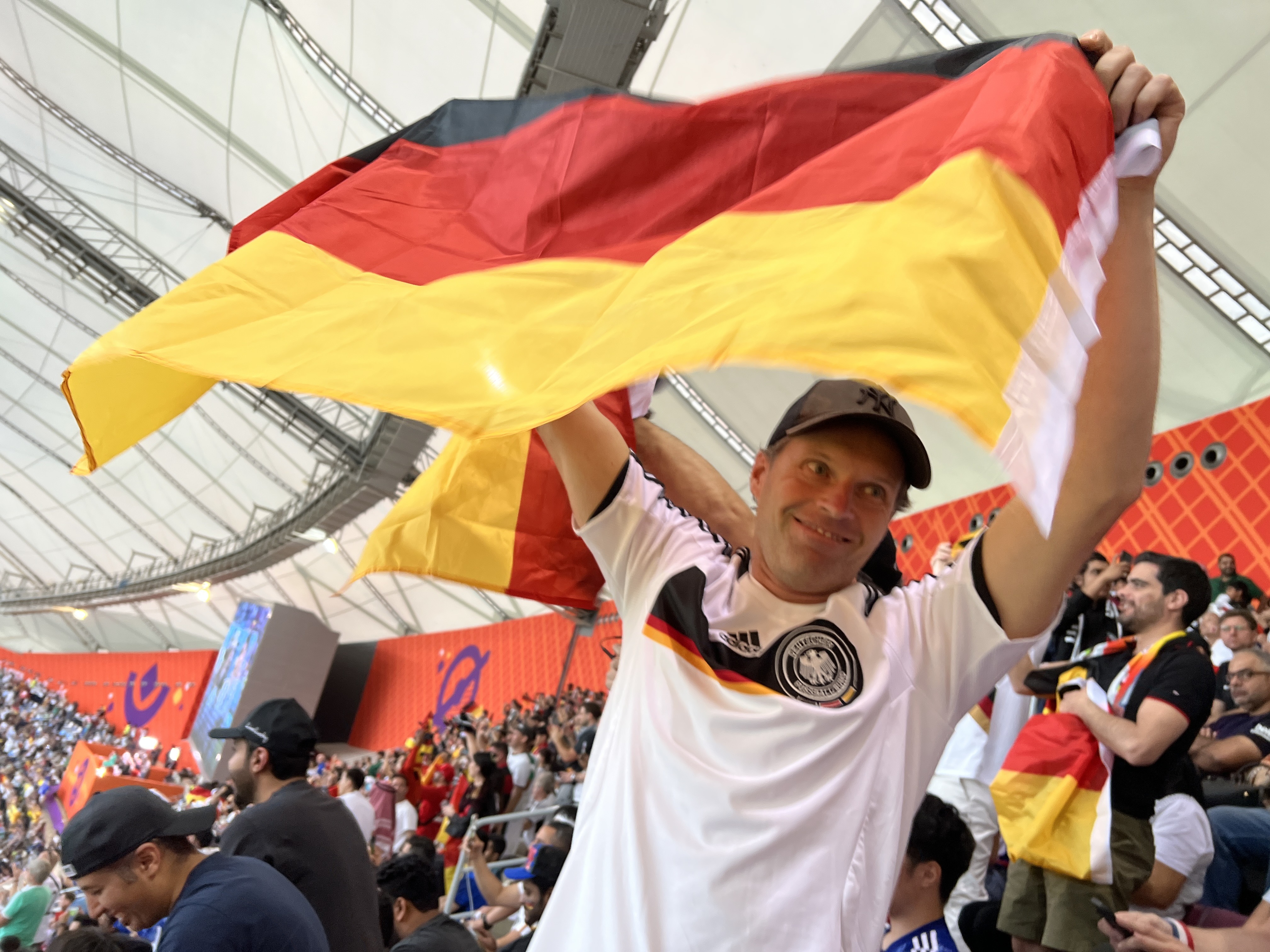 Germany fan Nick Boettcher waves a German flag in the Khalifa International Stadium on November 23.
