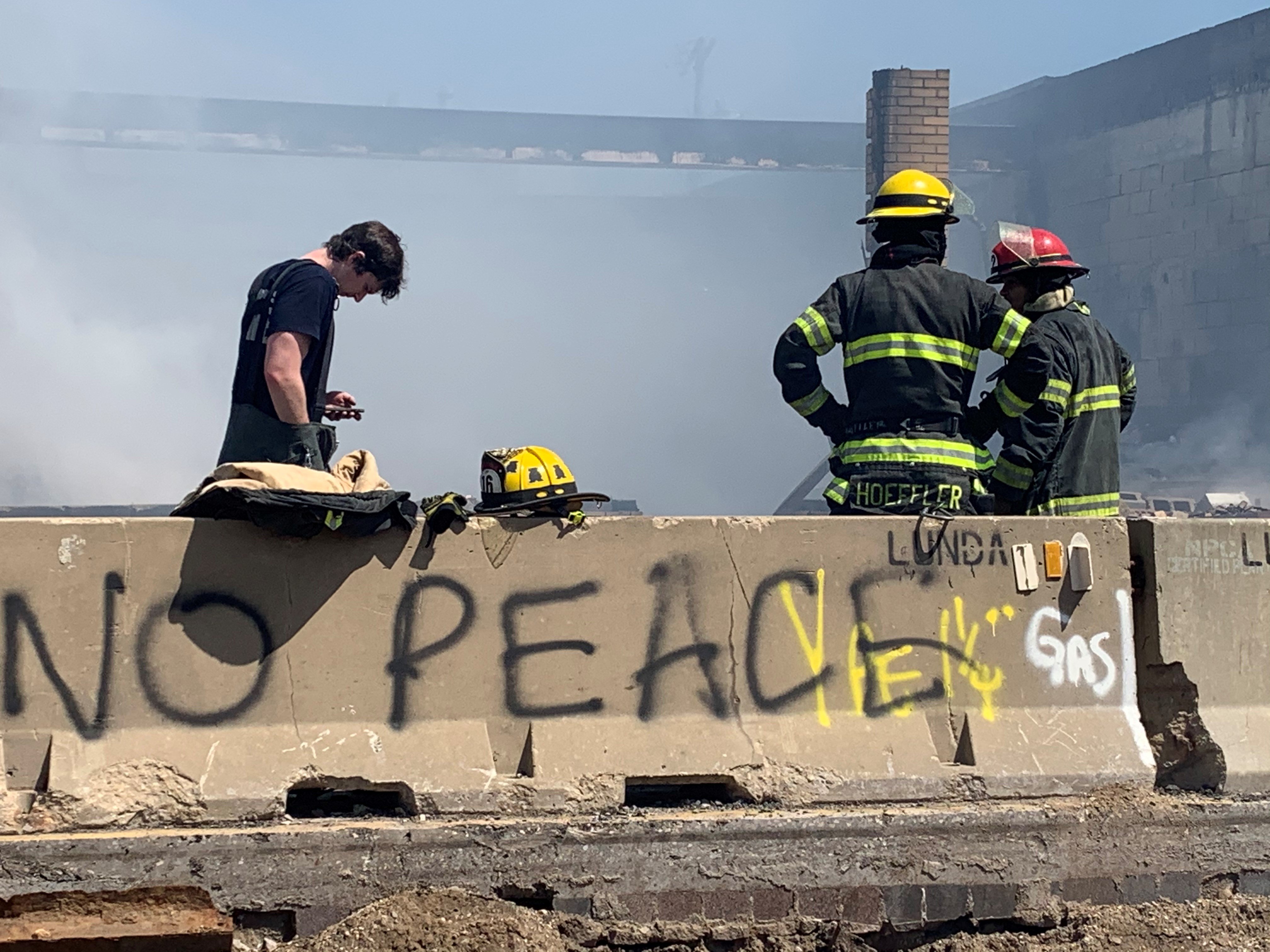 Minnesota firefighters take a break from battling protest fires on May 30.