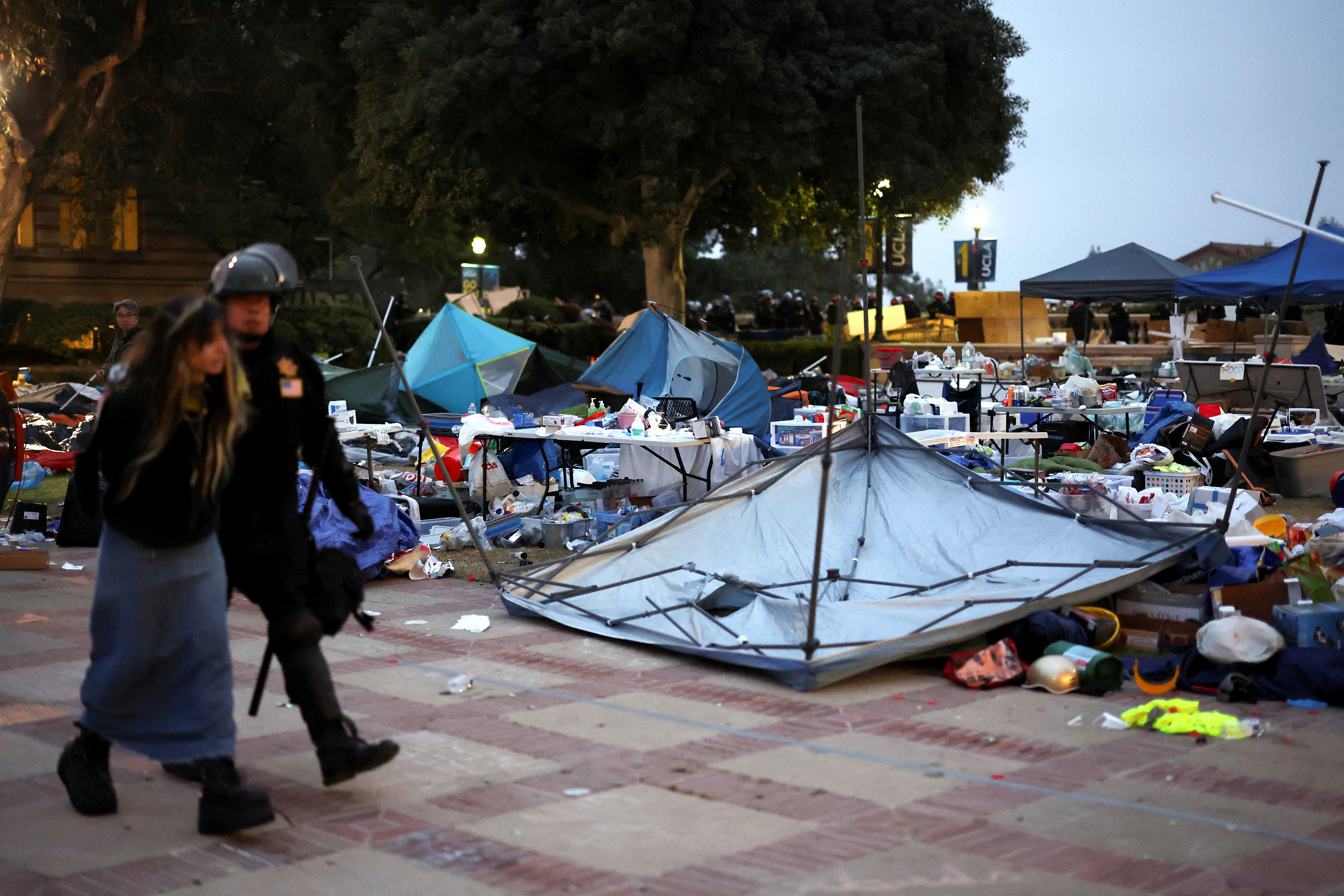 A protester is detained as police clear the encampment. 