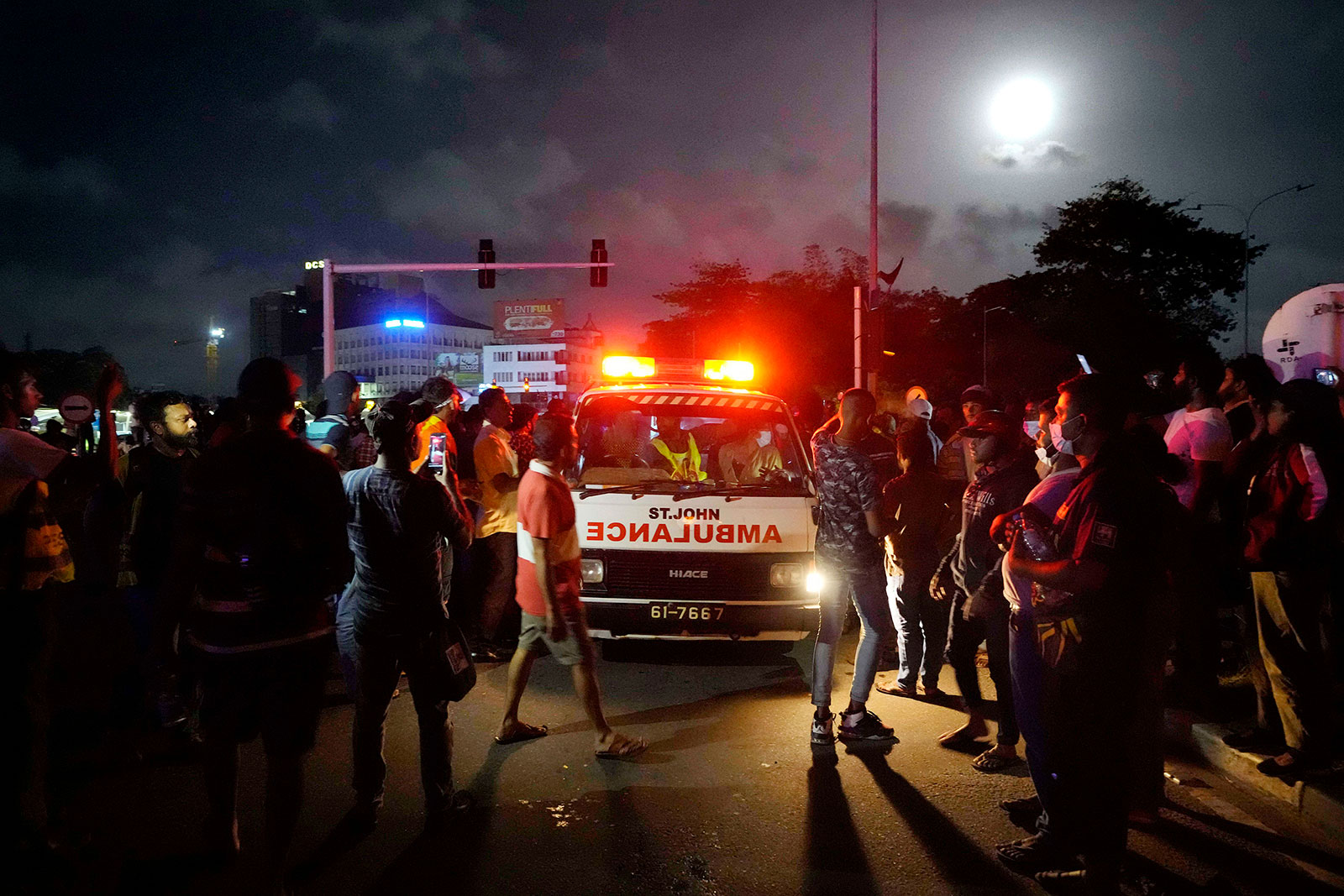 Protesters gather around an ambulance carrying injured after clashes with police near parliament in Colombo, Sri Lanka, on July 13.