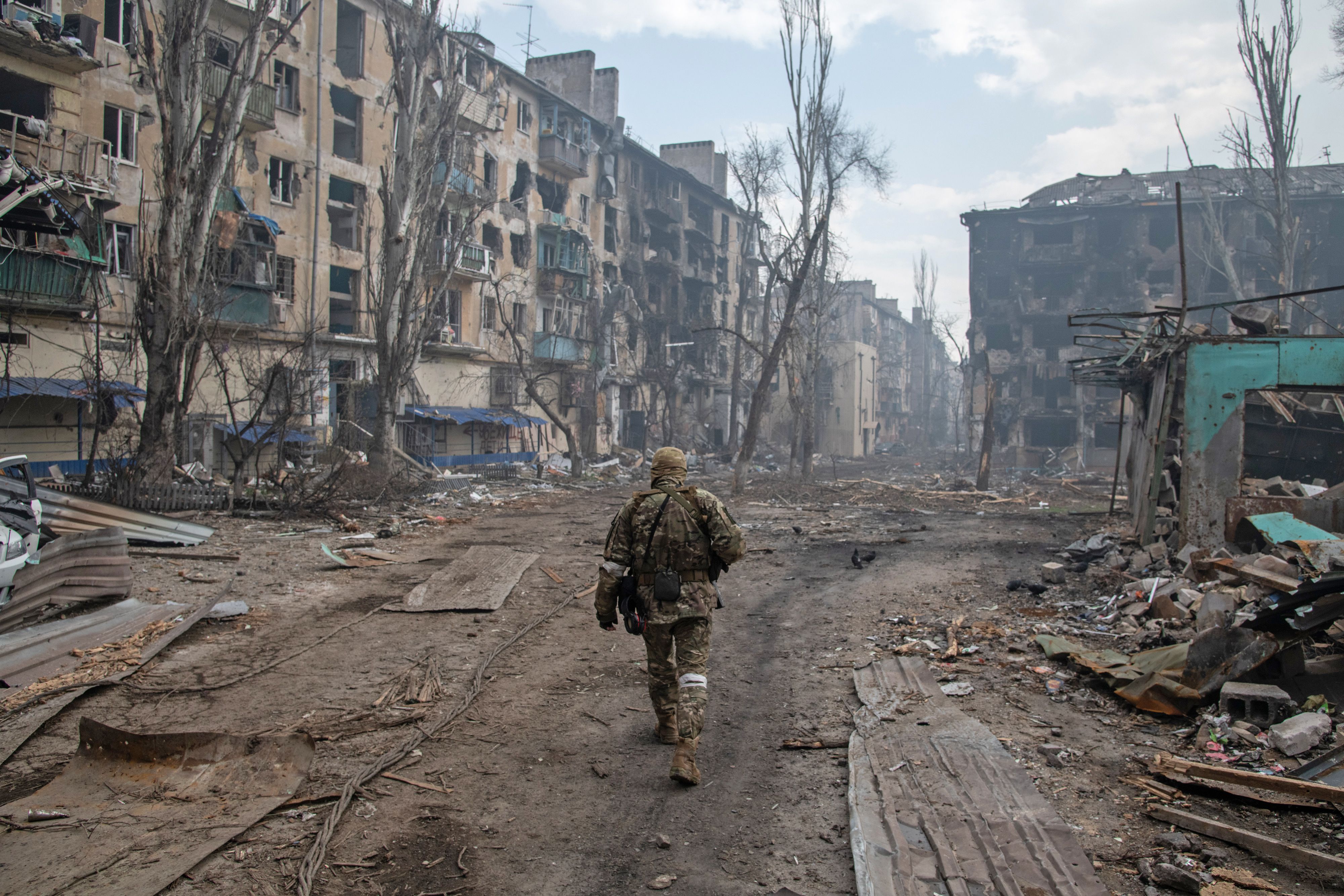 A Russian soldier walks among the rubble east of Mariupol on April 15.