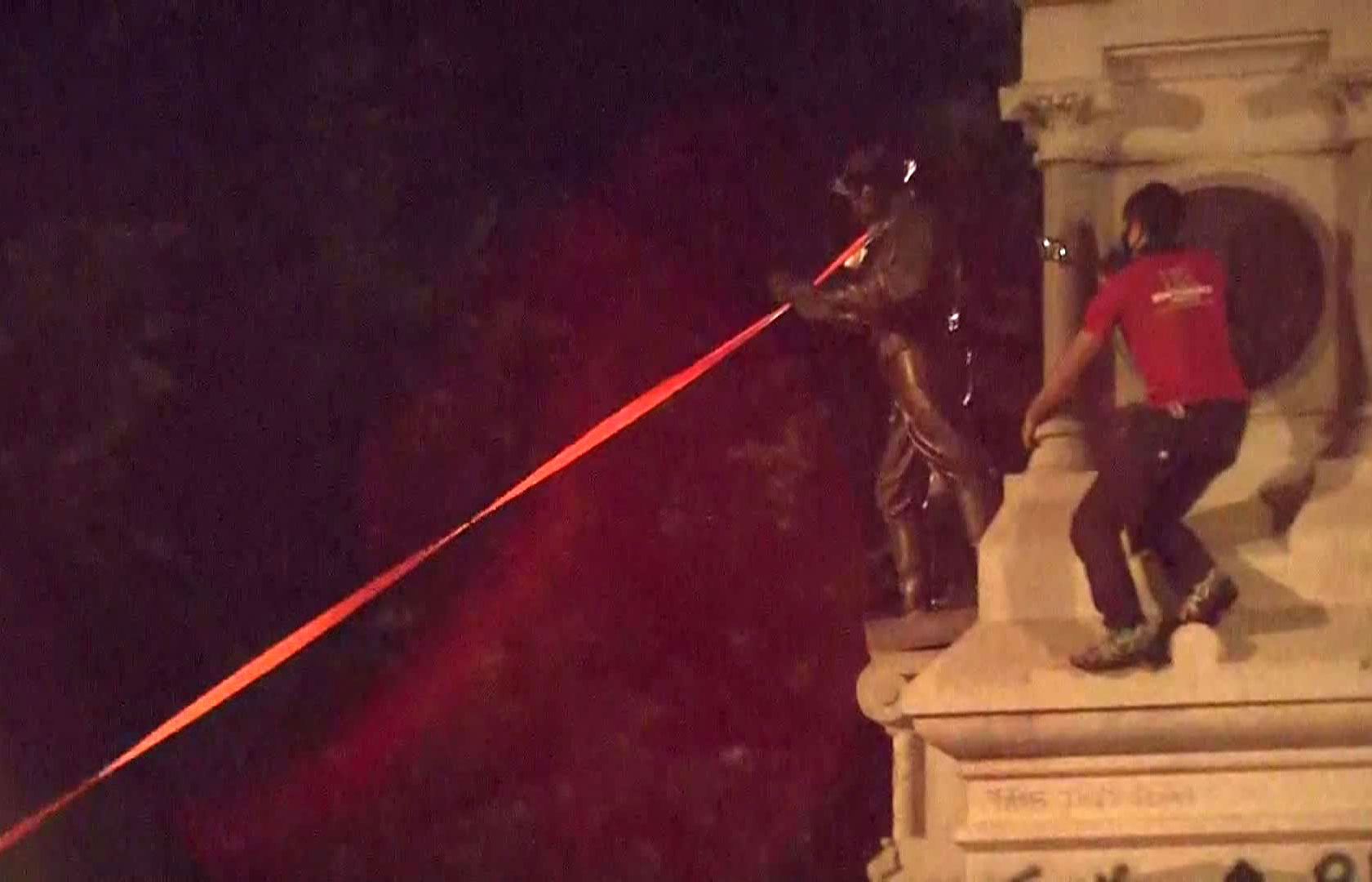 Protesters pull a statue down from a Confederate monument on Friday night in Raleigh, North Carolina.