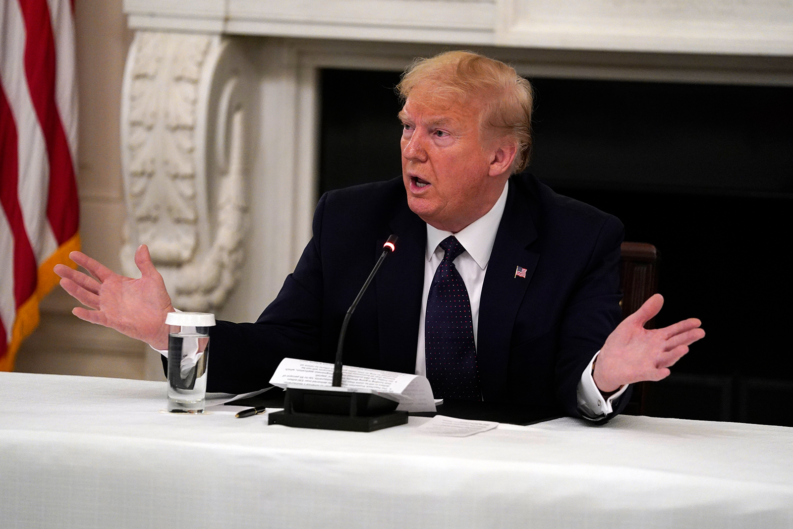 US President Donald Trump tells reporters that he is taking zinc and hydroxychloroquine during a meeting in the State Dining Room of the White House, on Monday, in Washington.
