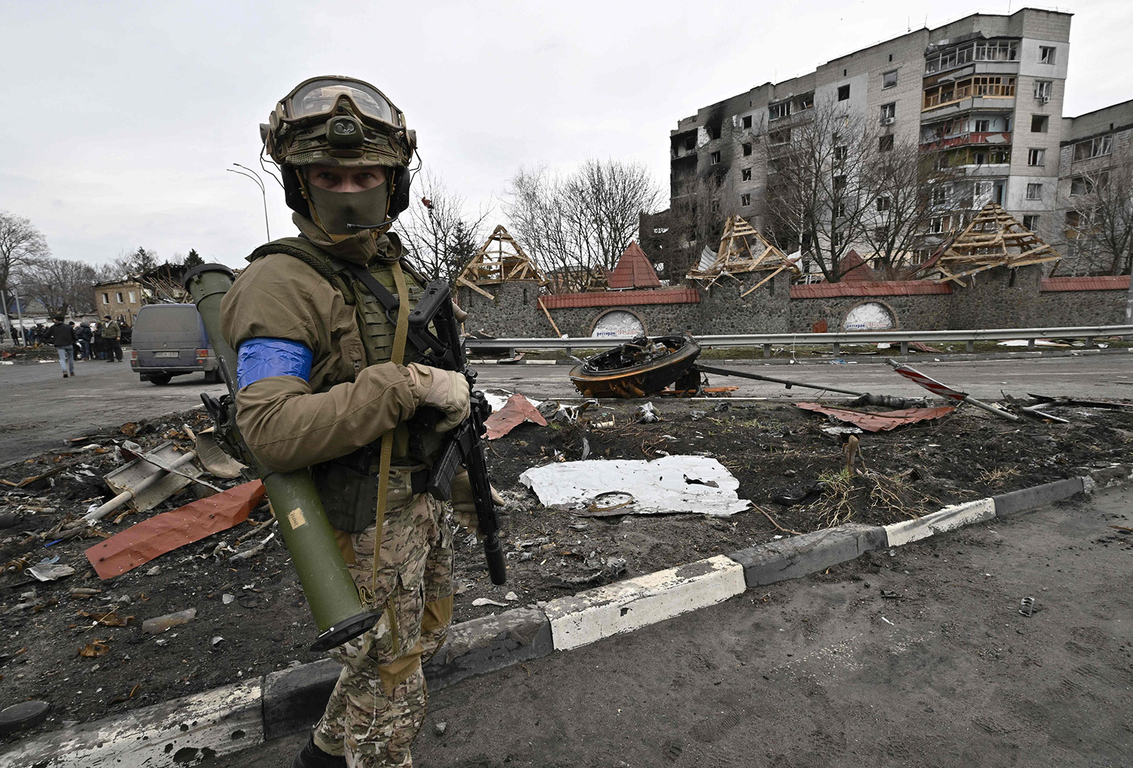 A Ukrainian serviceman stands guard on a street beside a damaged building in the town of Borodianka on Wednesday, April 6. 