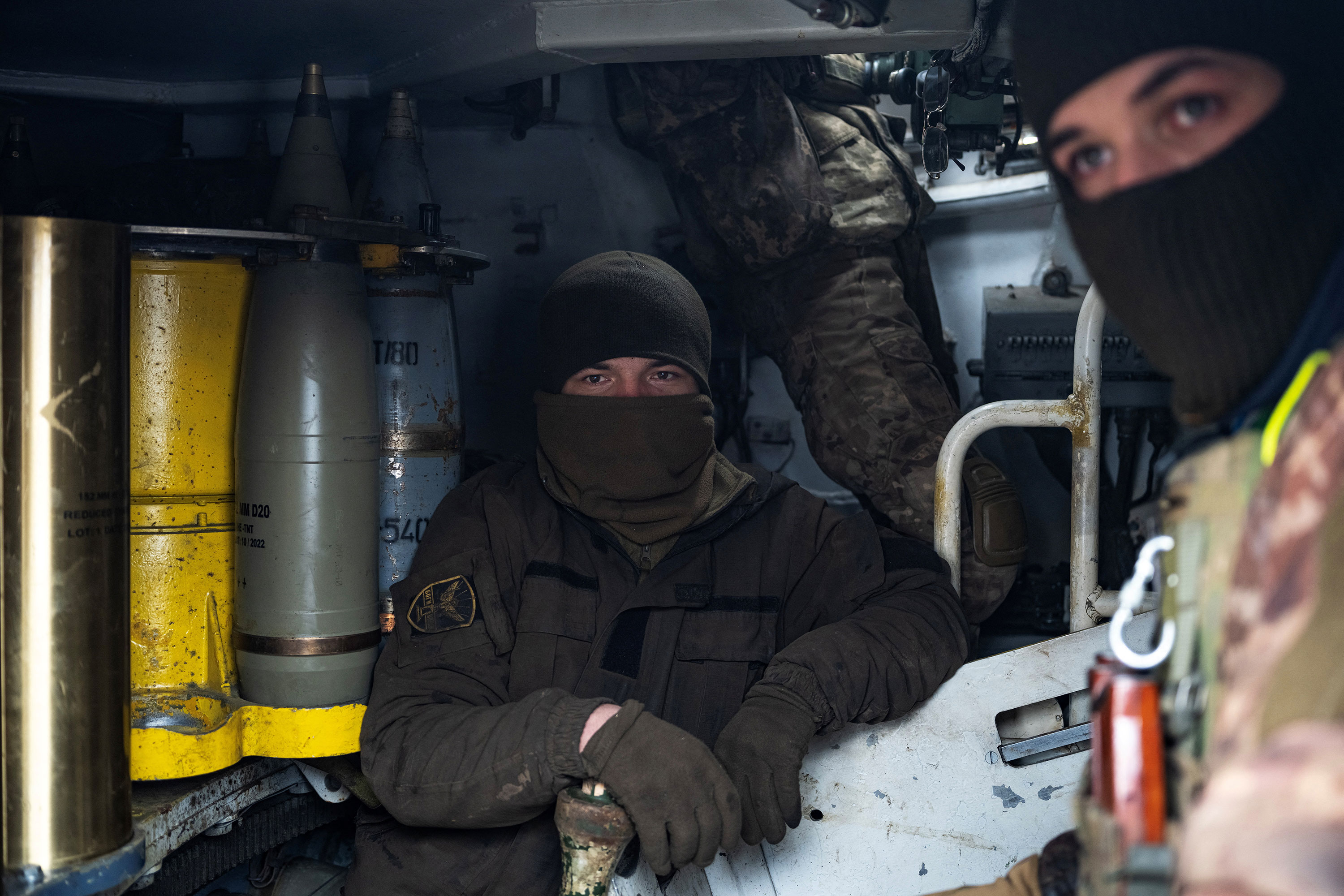Ukrainian servicemen sit inside a howitzer near Bakhmut on February 25. 