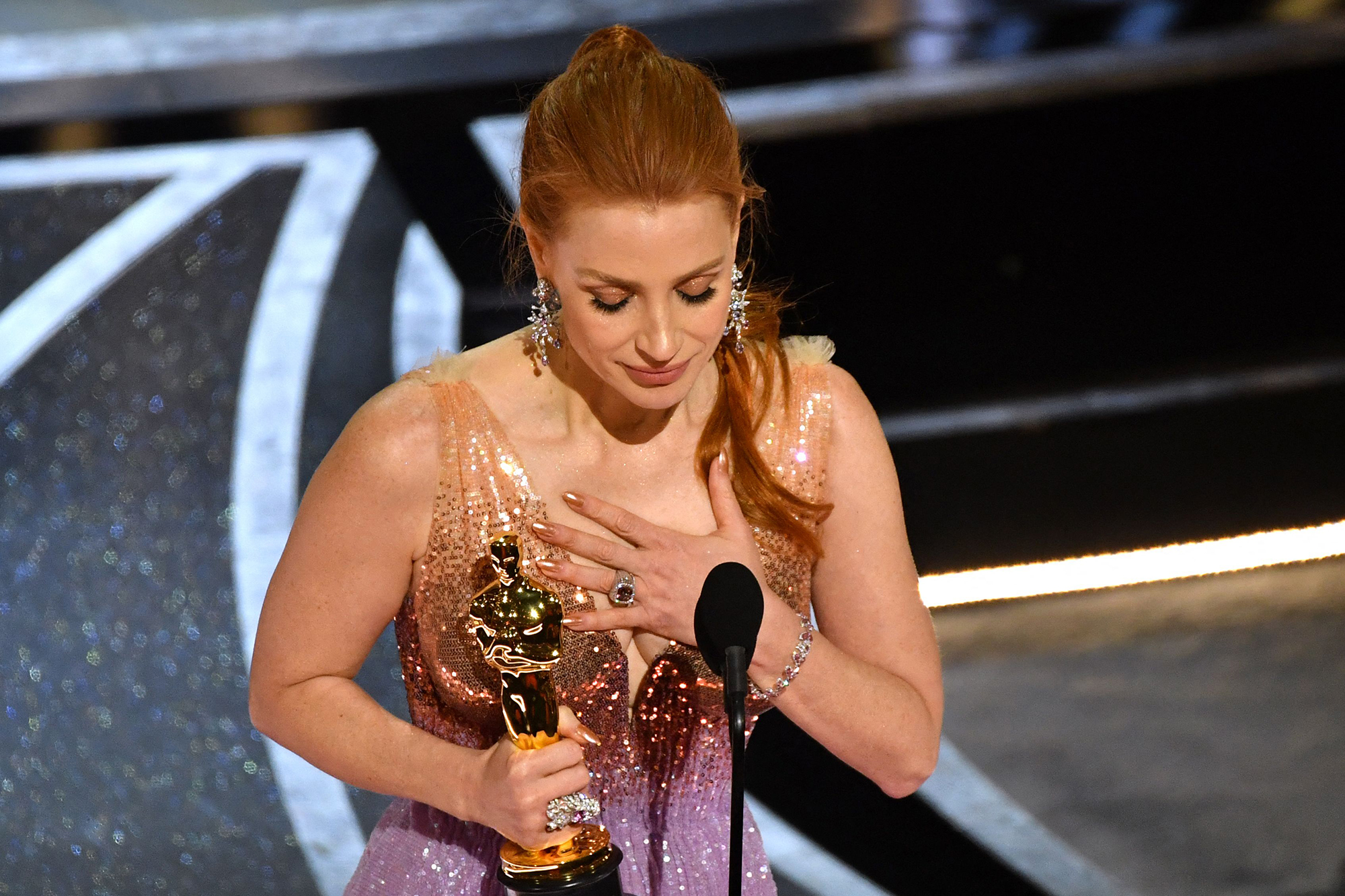 Jessica Chastain accepts the actress in a leading role award for “The Eyes of Tammy Faye.”