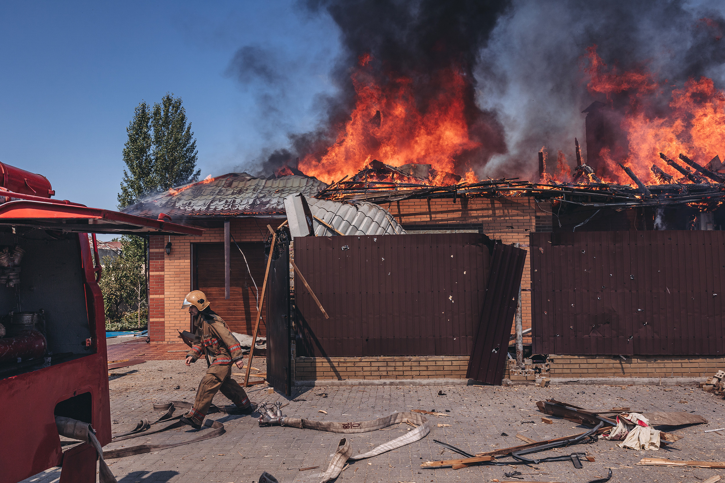 Firefighters tackle a blaze after the Russian shelling of a house in Bakhmut, Ukraine, on 27 July.