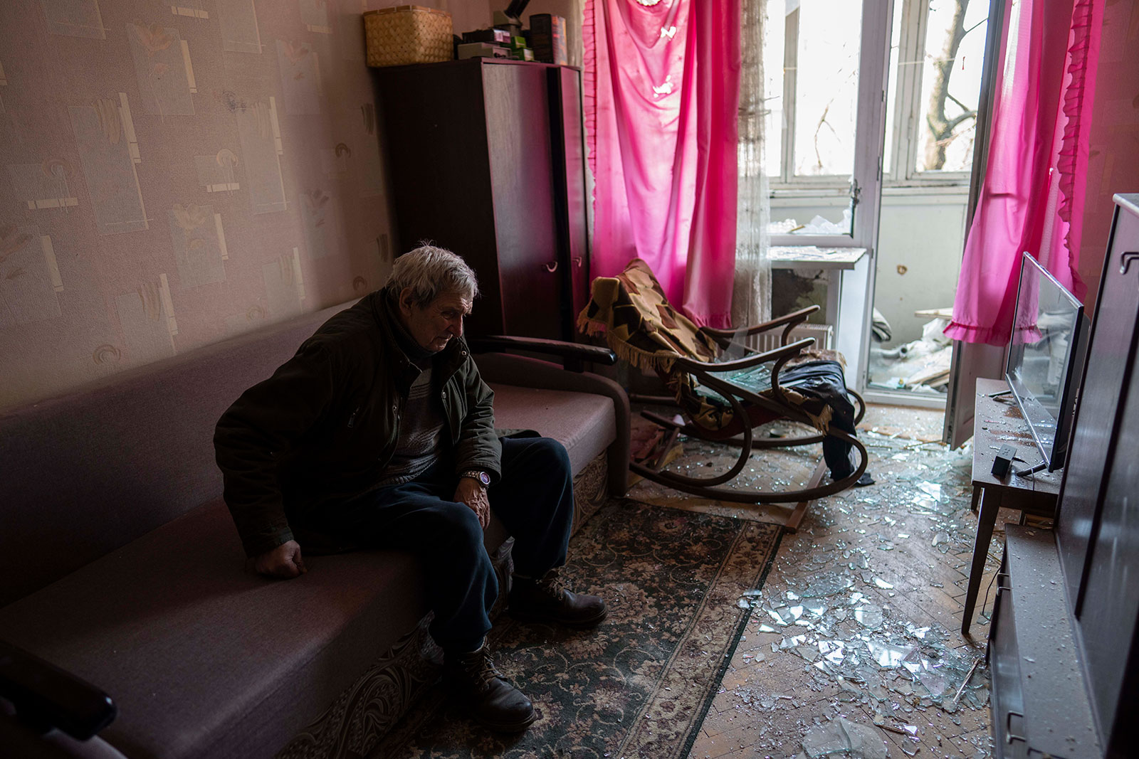 Volodymyr, 80, rests inside his apartment damaged by shelling in Kyiv on Wednesday, March 23.