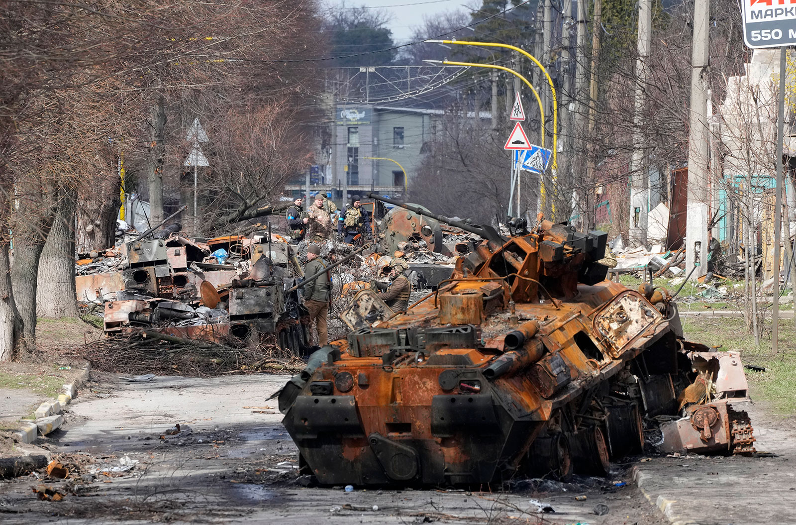 Ukrainian soldiers examine destroyed Russian military vehicles in the Kyiv suburb of Bucha on Monday, April 4. 
