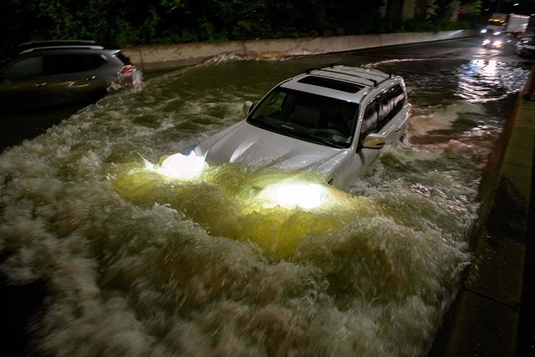A motorist drives on a flooded expressway in Brooklyn, New York, early on Thursday, September 2, as the remnants of Hurricane Ida swept through the area.