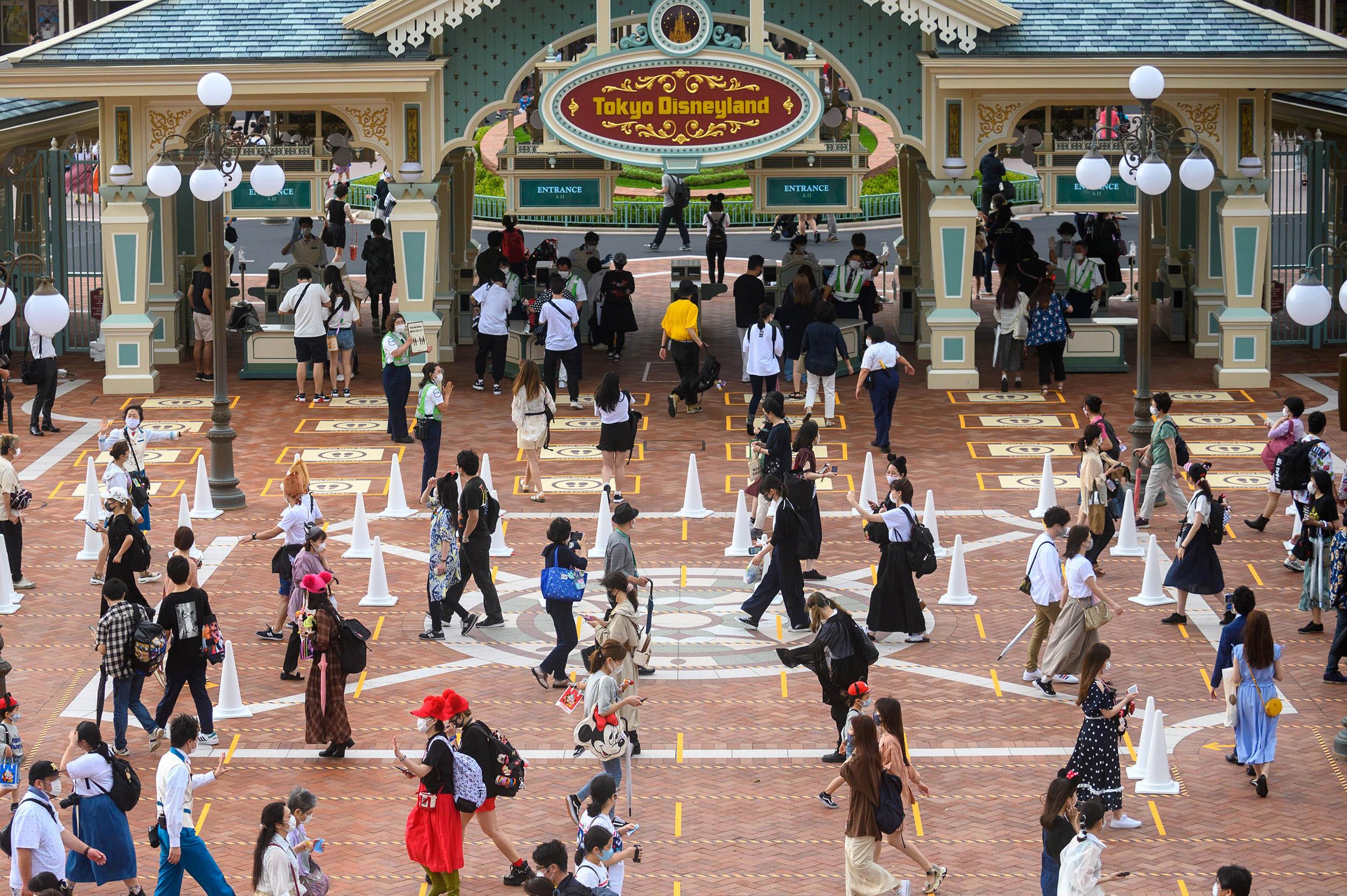 People arrive at Tokyo Disneyland on the reopening day on July 1, in Tokyo, Japan. 