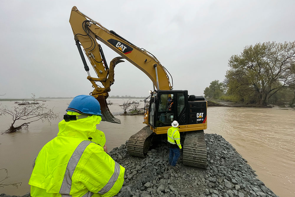 A crew works at repairing a levee rupture at the Pajaro River in Monterey County, California, on Tuesday, March 14.