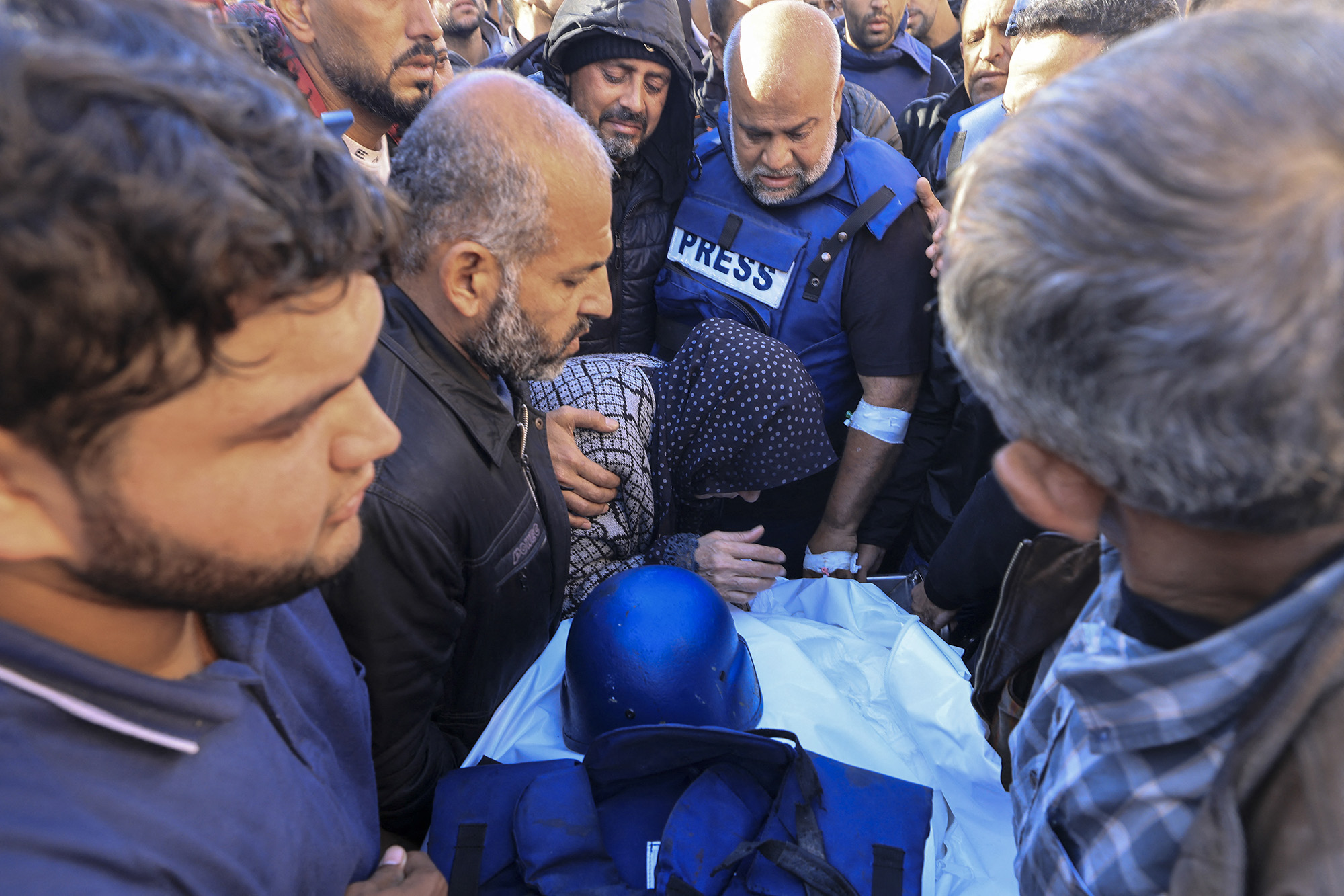 Colleagues and family members mourn over the body of Al Jazeera cameraman Samer Abu Daqa, who was killed during Israeli bombardment, during his funeral in Khan Younis, Gaza, on December 16.