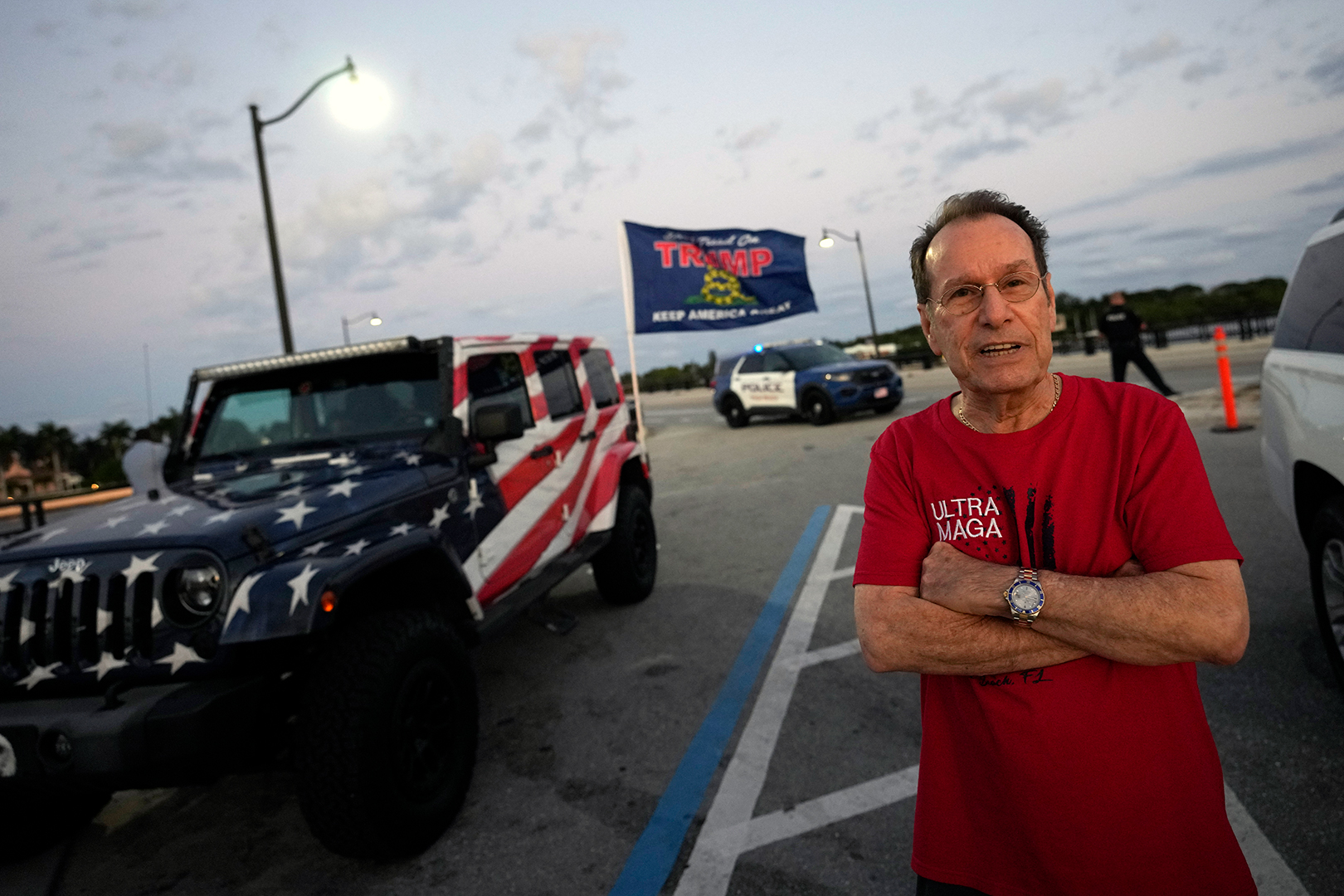 Amnon Shaleb of Boca Raton stands near his Jeep, decorated in the pattern of the American Flag, as he turns out to show support for former President Donald Trump.