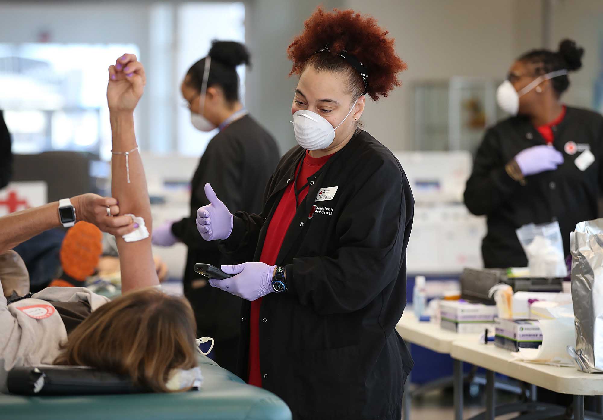 Belinda Ofilos, collection specialist, takes blood from a donor during a blood drive by the American Red Cross on March 31 in Norwood, Massachusetts.