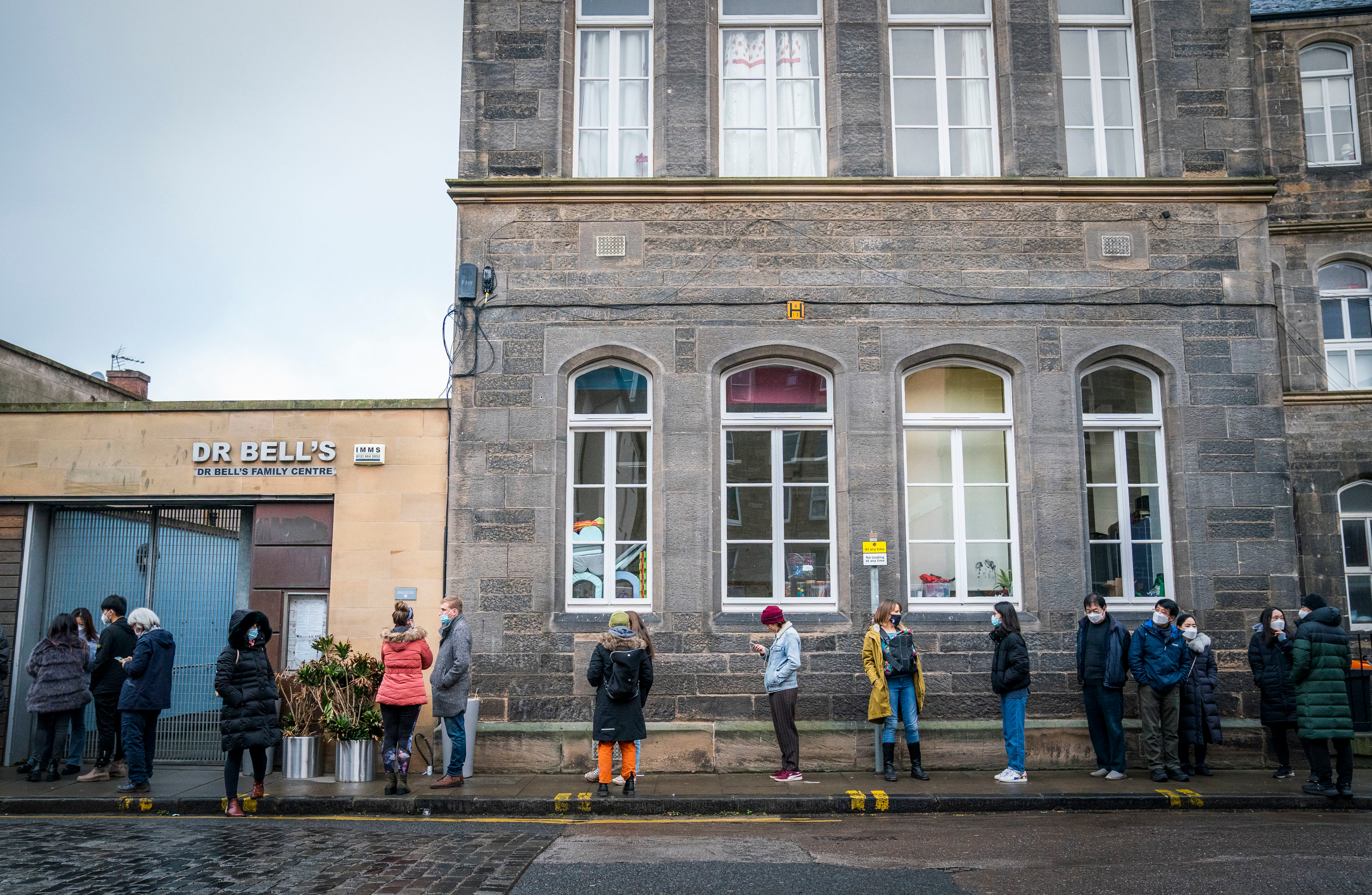 People line up outside a vaccination centre at the NHS Scotland Leith Community Treatment Centre, in Edinburgh, Scotland, on Monday, December 20.