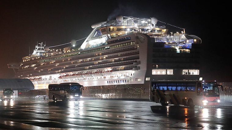 Buses carrying American passengers from the quarantined Diamond Princess cruise ship leave a port in Yokohama, Japan on Monday, February 17.