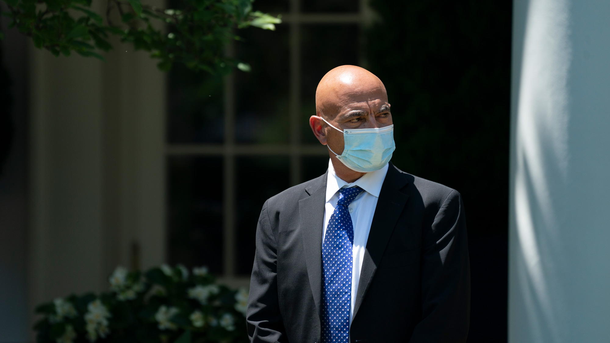 Moncef Slaoui listens as U.S. President Donald Trump delivers remarks about coronavirus vaccine development in the Rose Garden of the White House on May 15 in Washington, DC. 