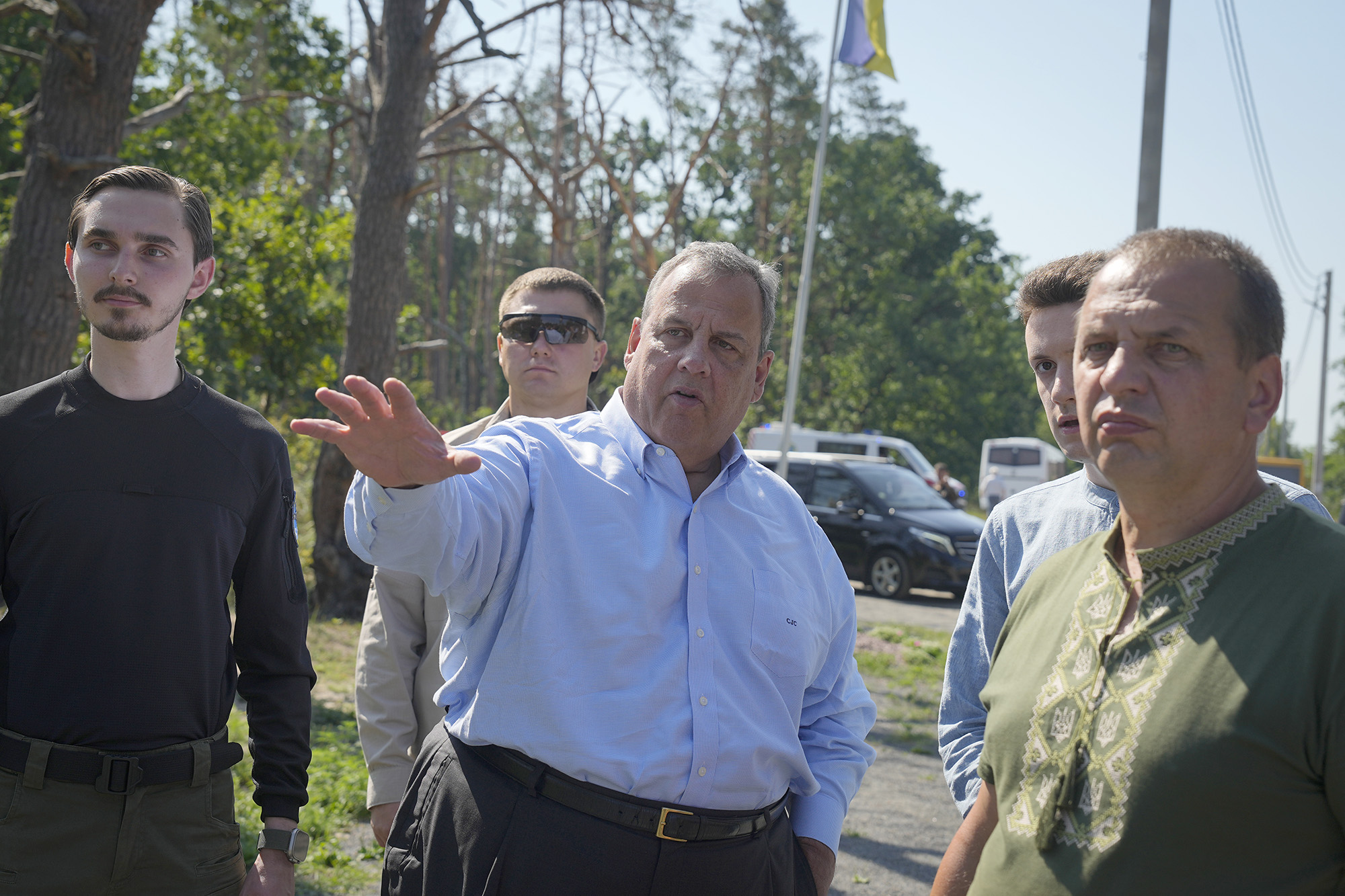 Republican presidential candidate Chris Christie, center, speaks with activists as he visits the village of Moshchun on the outskirts of Kyiv, Ukraine, on August 4.