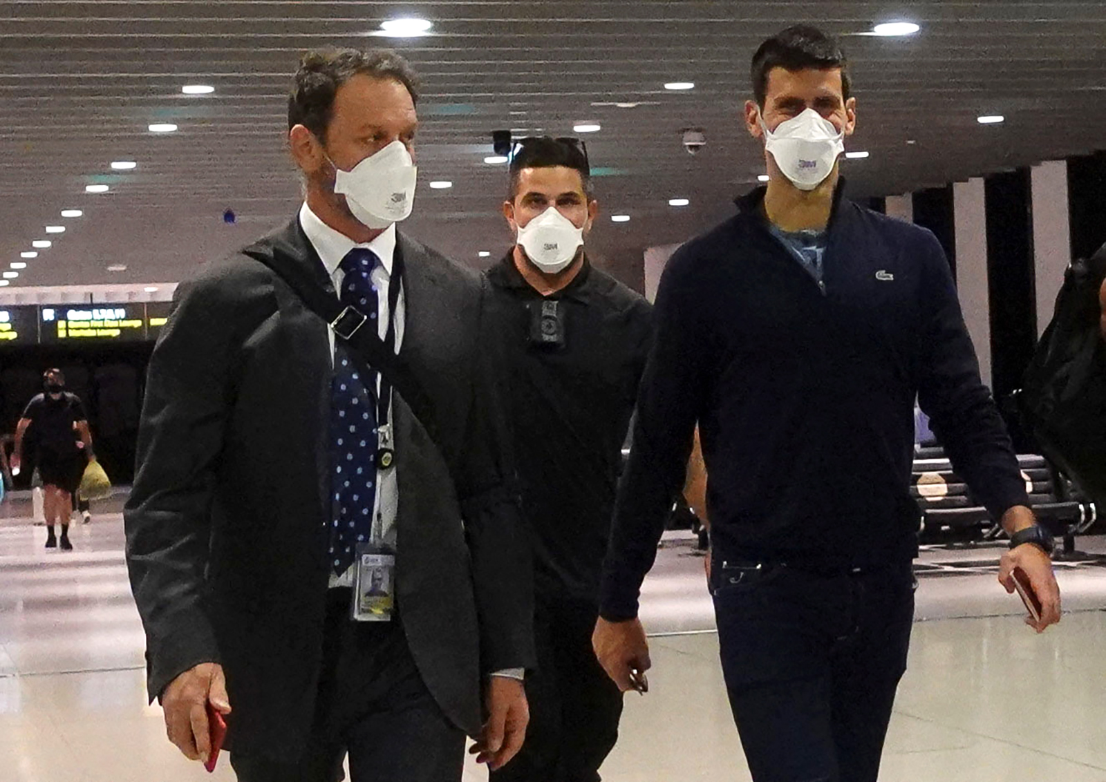 Novak Djokovic walks in Melbourne Airport before boarding a flight on January 16, after the Federal Court upheld a government decision to cancel his visa to play in the Australian Open. 