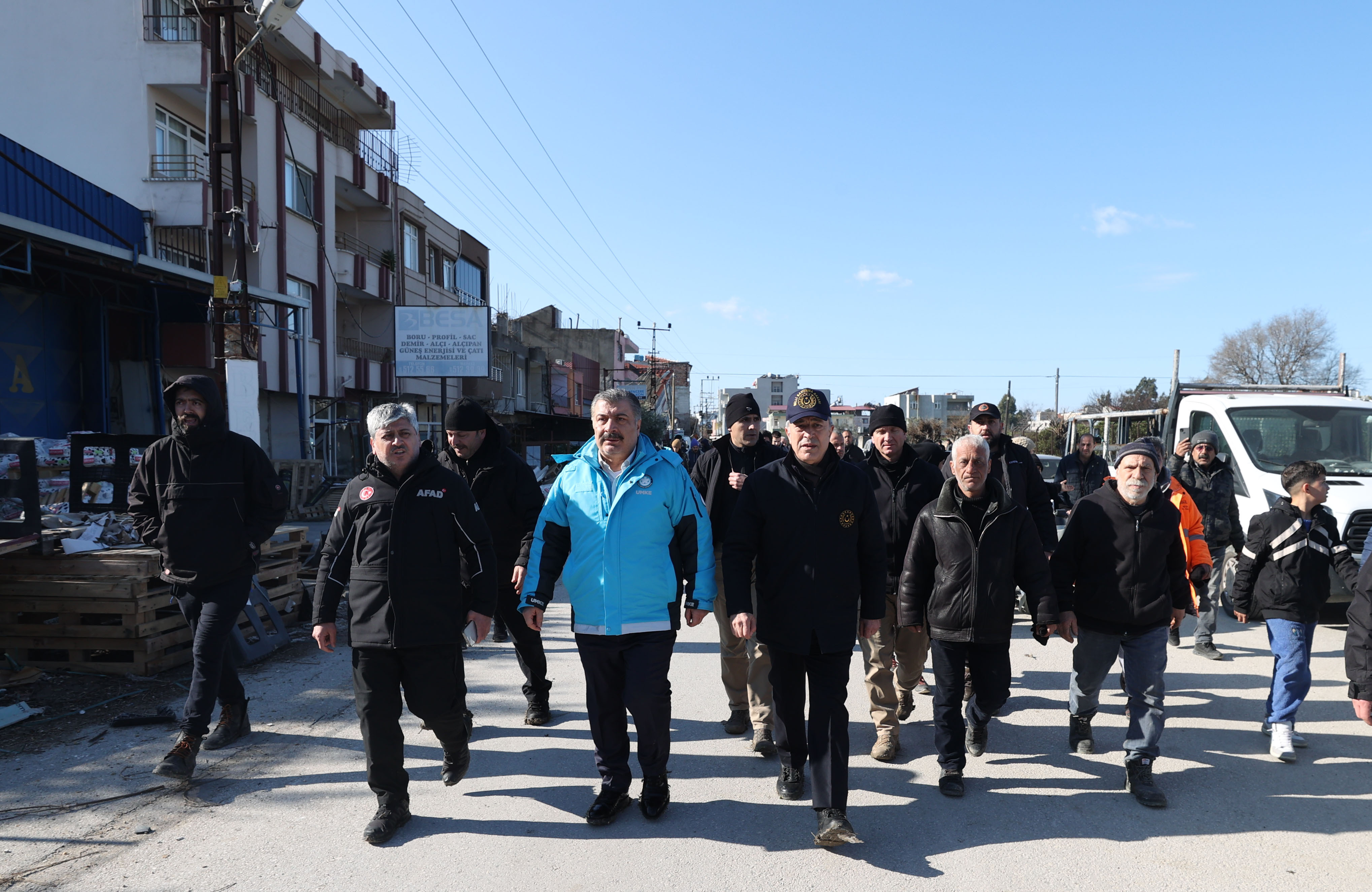 Turkish Health Minister Fahrettin Koca, center left, in blue, and Turkish Defense Minister Hulusi Akar, center right, visit Hatay, Turkey, in the aftermath of the earthquake, on Wednesday, February 8. 