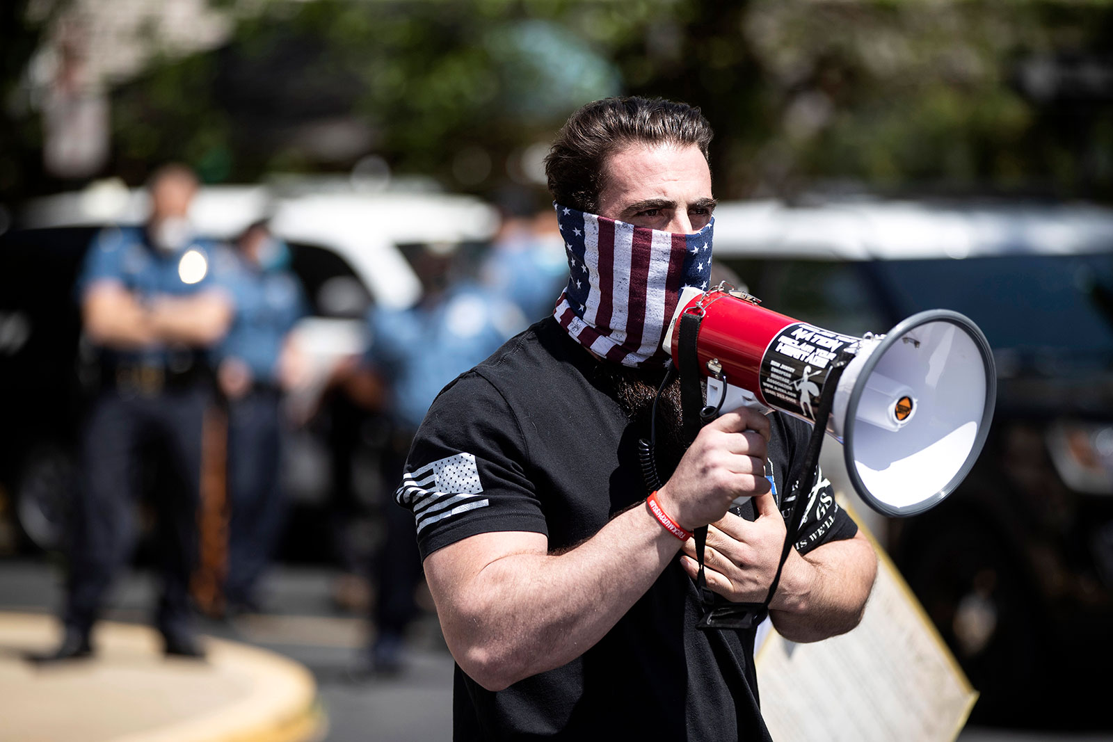 Ian Smith, co-owner of Atilis Gym, speaks into a megaphone outside of his gym in Bellmawr, New Jersey, on May 18.