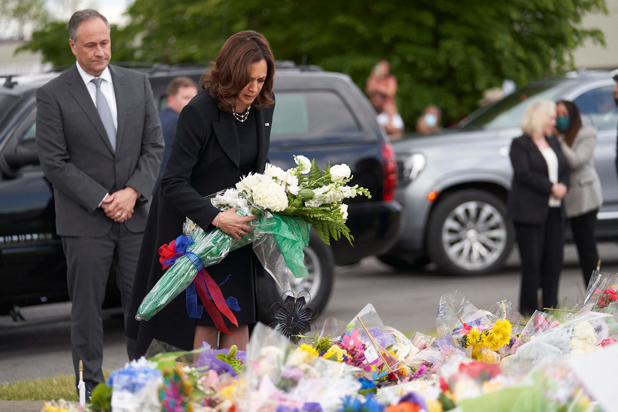 Harris places flowers at the scene of the mass shooting at Tops supermarket in Buffalo, New York, on May 28. 