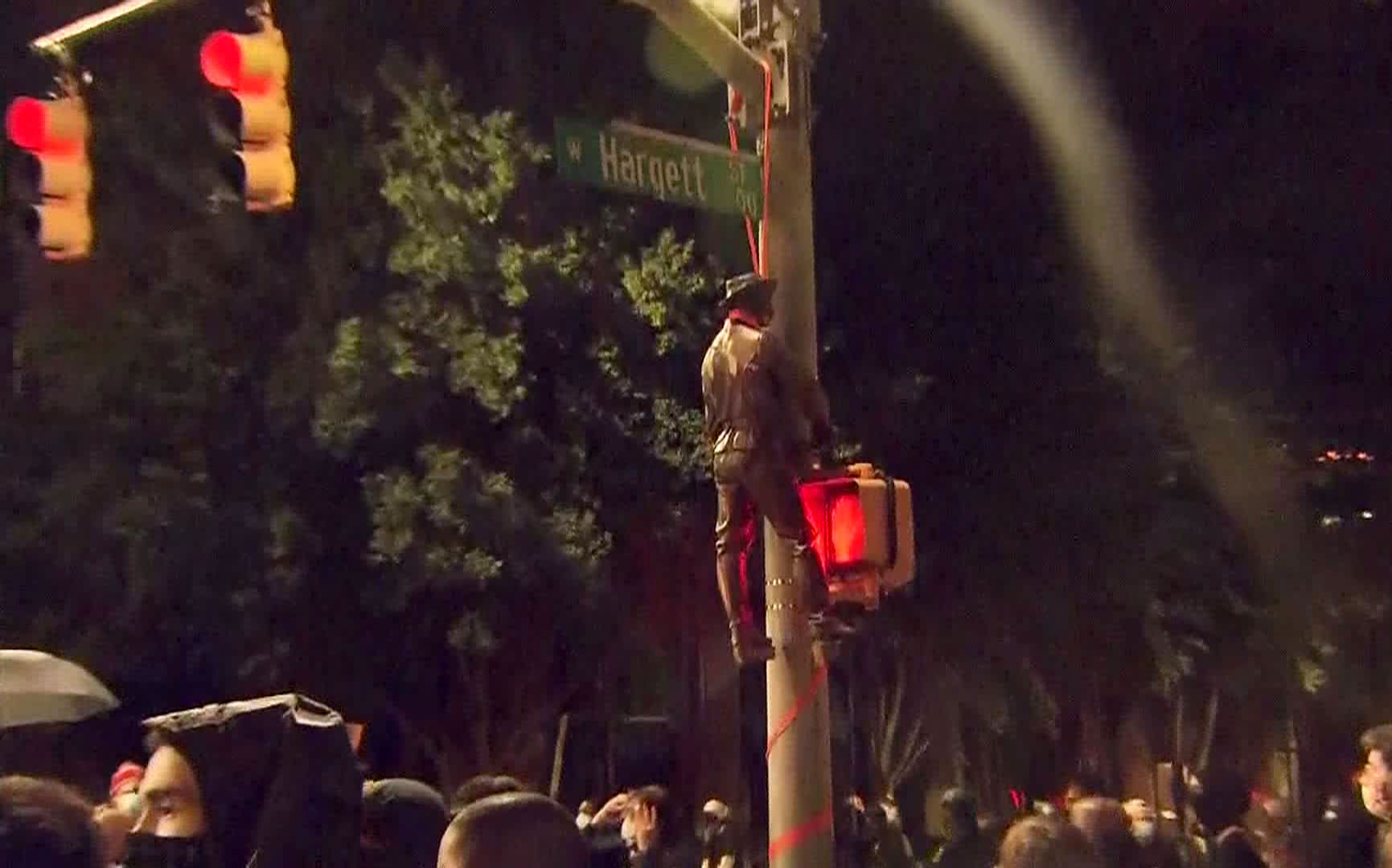 Protesters hang a Confederate statue from a light post on Friday, June 19 in Raleigh, North Carolina.