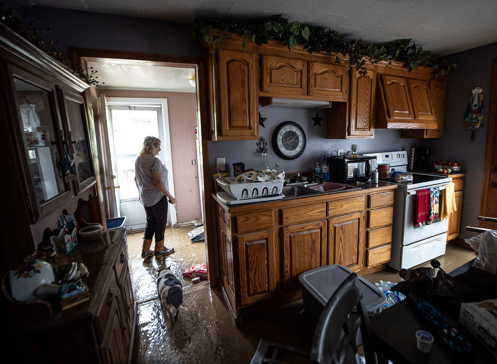 Pam Boling surveys the damage to her home from floodwaters in Wayland, Kentucky, following a day of heavy rain on July 28.