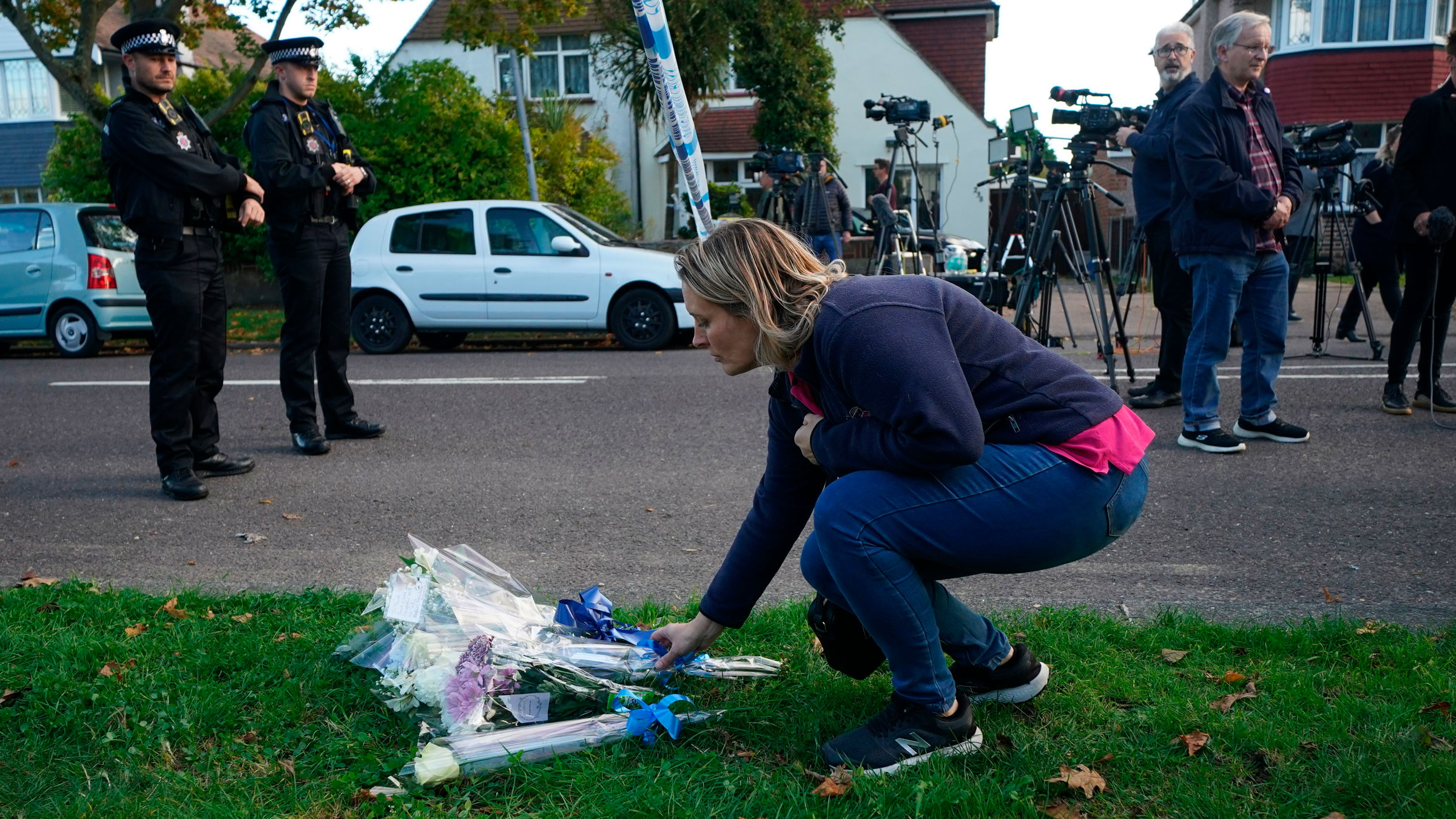 A woman lays flowers for David Amess on Friday.