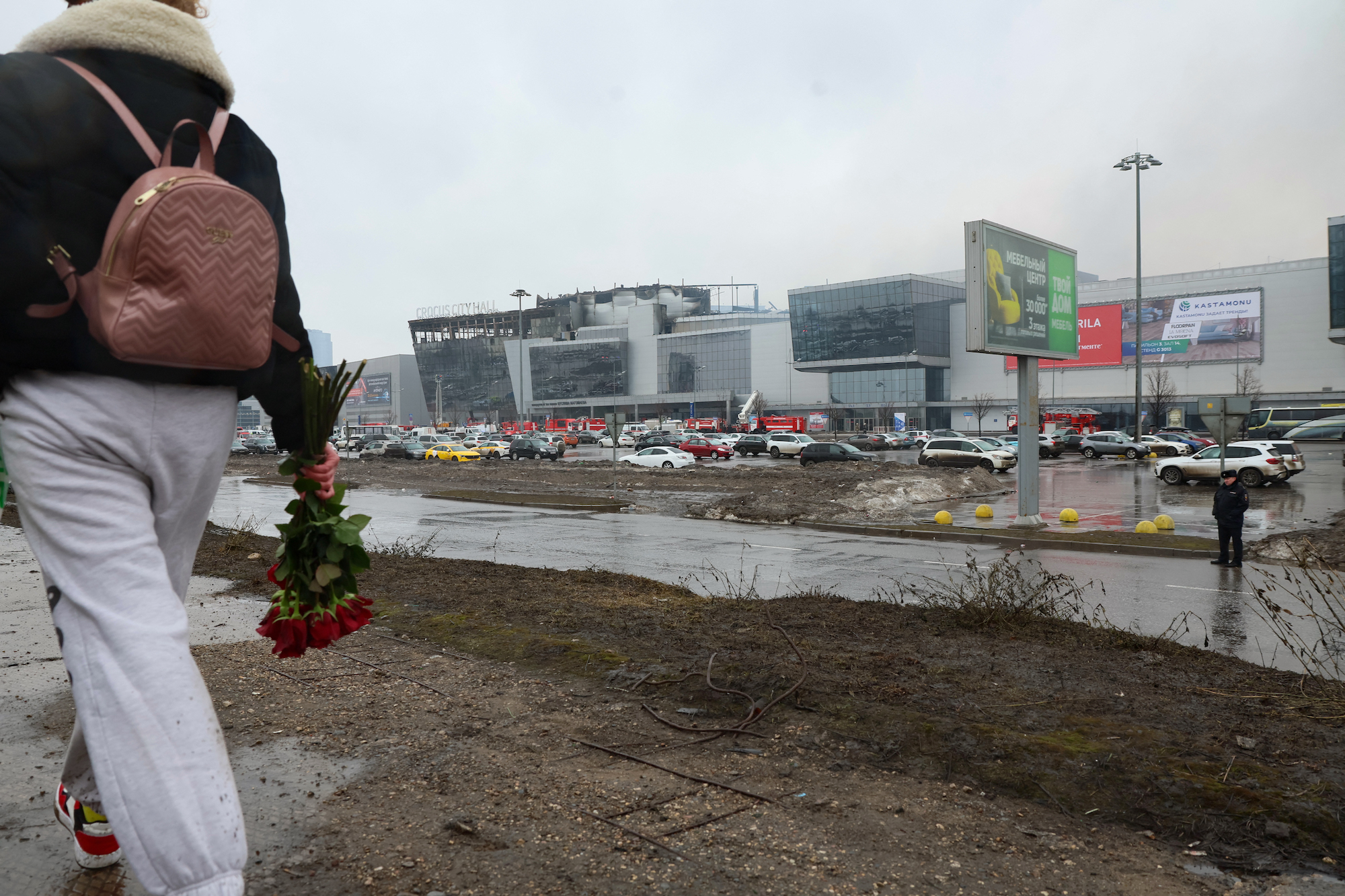 A woman walks to lay flowers at the Crocus City Hall concert hall in Krasnogorsk, outside Moscow, on Saturday.
