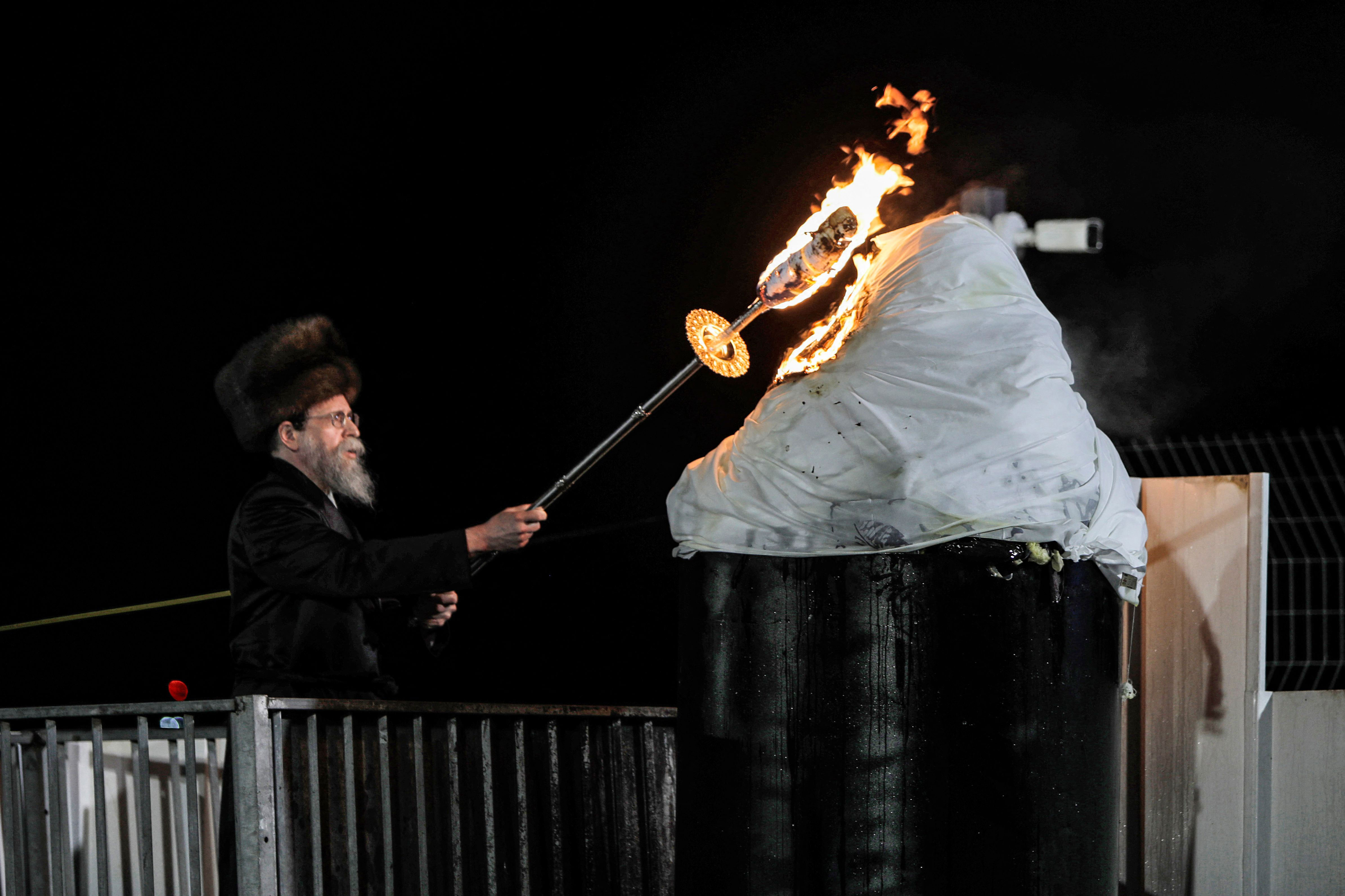 A rabbi lights a bonfire at the grave site of Rabbi Shimon Bar Yochai. Up to 100,000 Jews are estimated to have attended last night's event. 