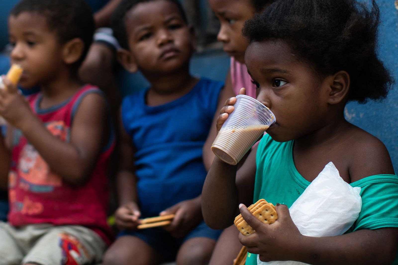 Children eat breakfast during food distribution in Rio de Janeiro, Brazil, on May 24.