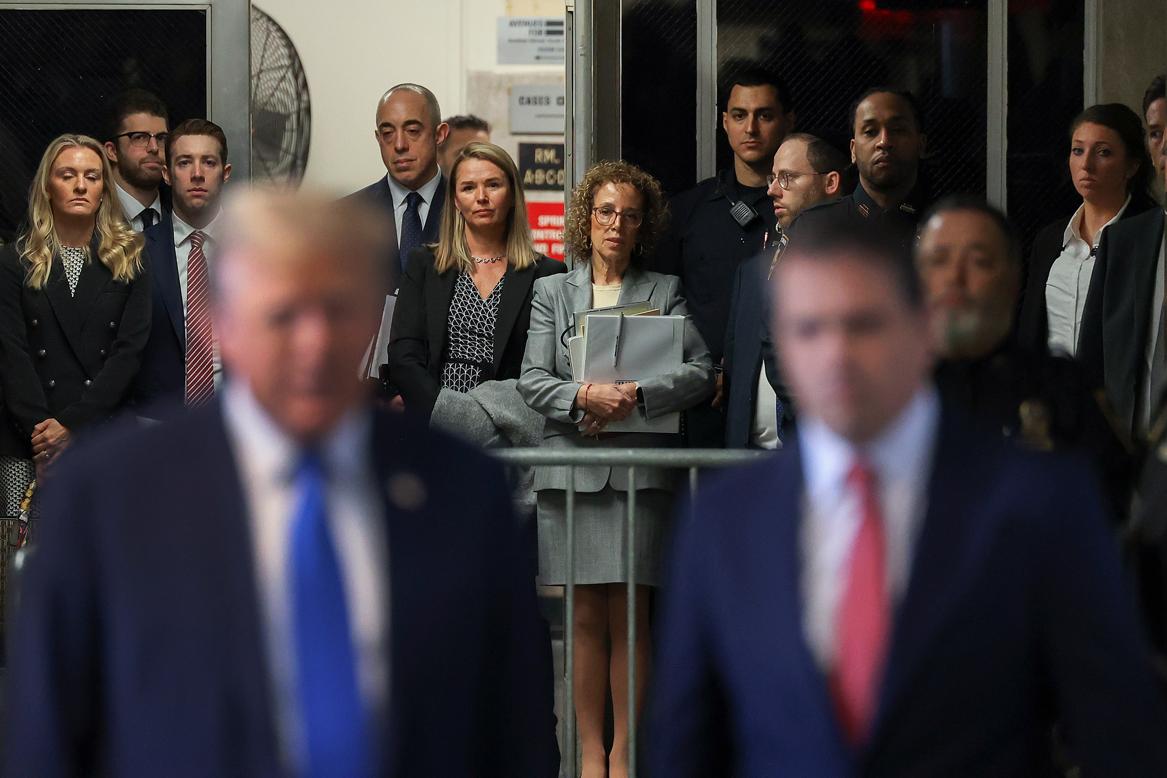 Former president Donald Trump's defense team stops to listen as Trump speaks upon arriving at Manhattan criminal court, Monday, April 22, in New York. 