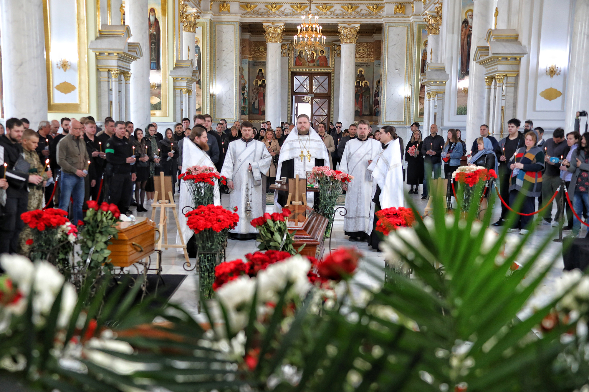 Priests conduct the funeral service of Valeriia Hlodan, her three-month-old baby girl Kira and her mother Liudmyla Yavkina at Transfiguration Cathedral, Odesa, southern Ukraine, on April 27. 