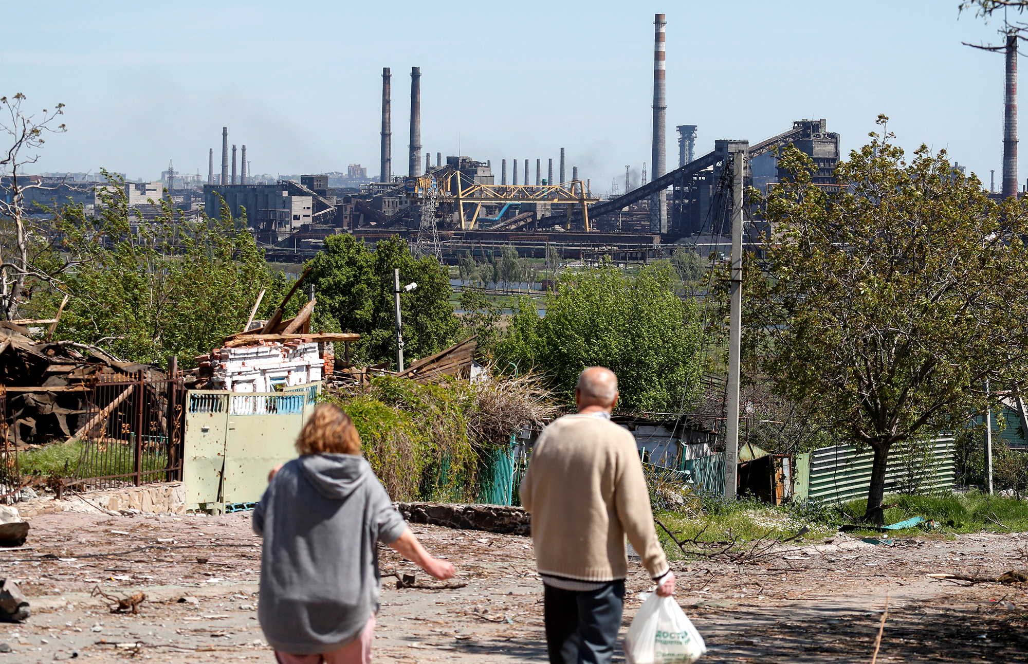People walk near the Azovstal steel plant in Mariupol, Ukraine, on May 12. 