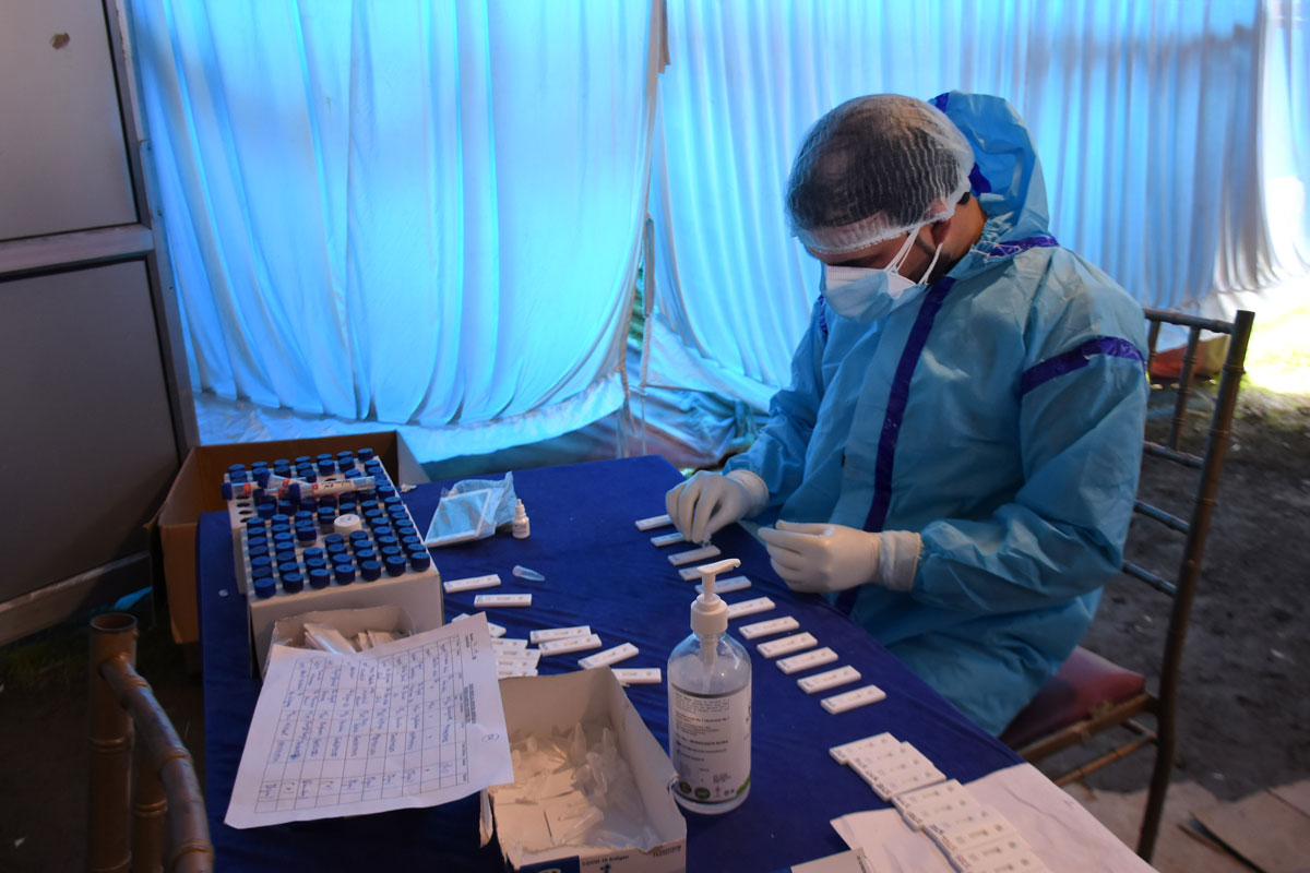A health worker prepares a Covid-19 test sample at a testing centre in Srinagar, India on April 21.