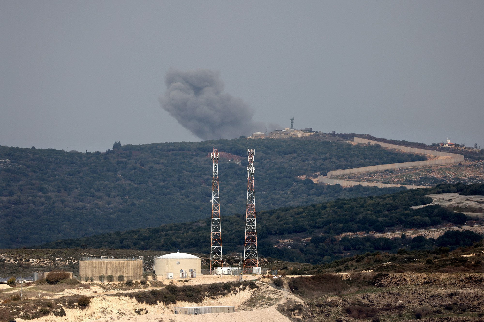 A picture taken from the Israeli side of border with Lebanon shows Israeli shelling around the southern Lebanese village of Aita al-Shaab on December 5.