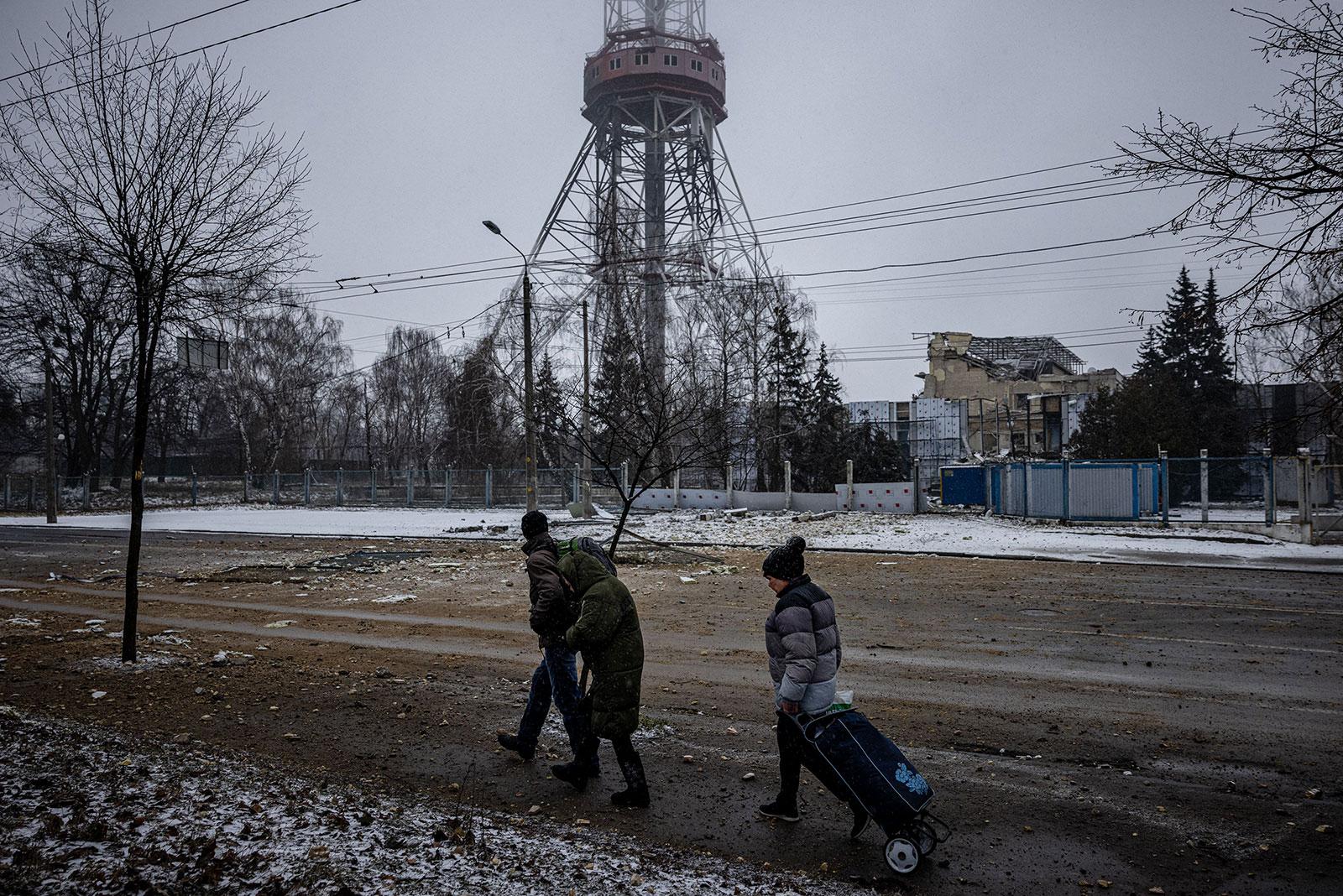 People walk past the site of Tuesday's airstrike that hit Kyiv's TV tower.
