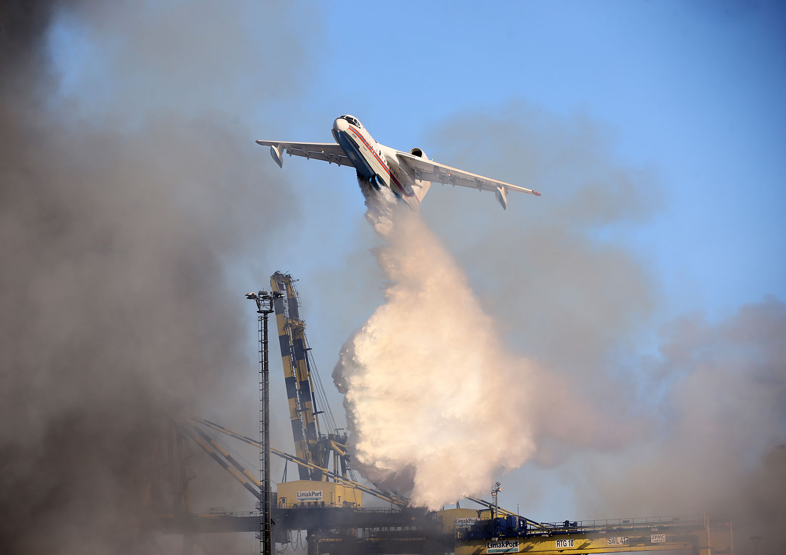 A firefighting plane drops water on February 9 to extinguish a major fire that broke out at the Iskenderun port in Turkey. 
