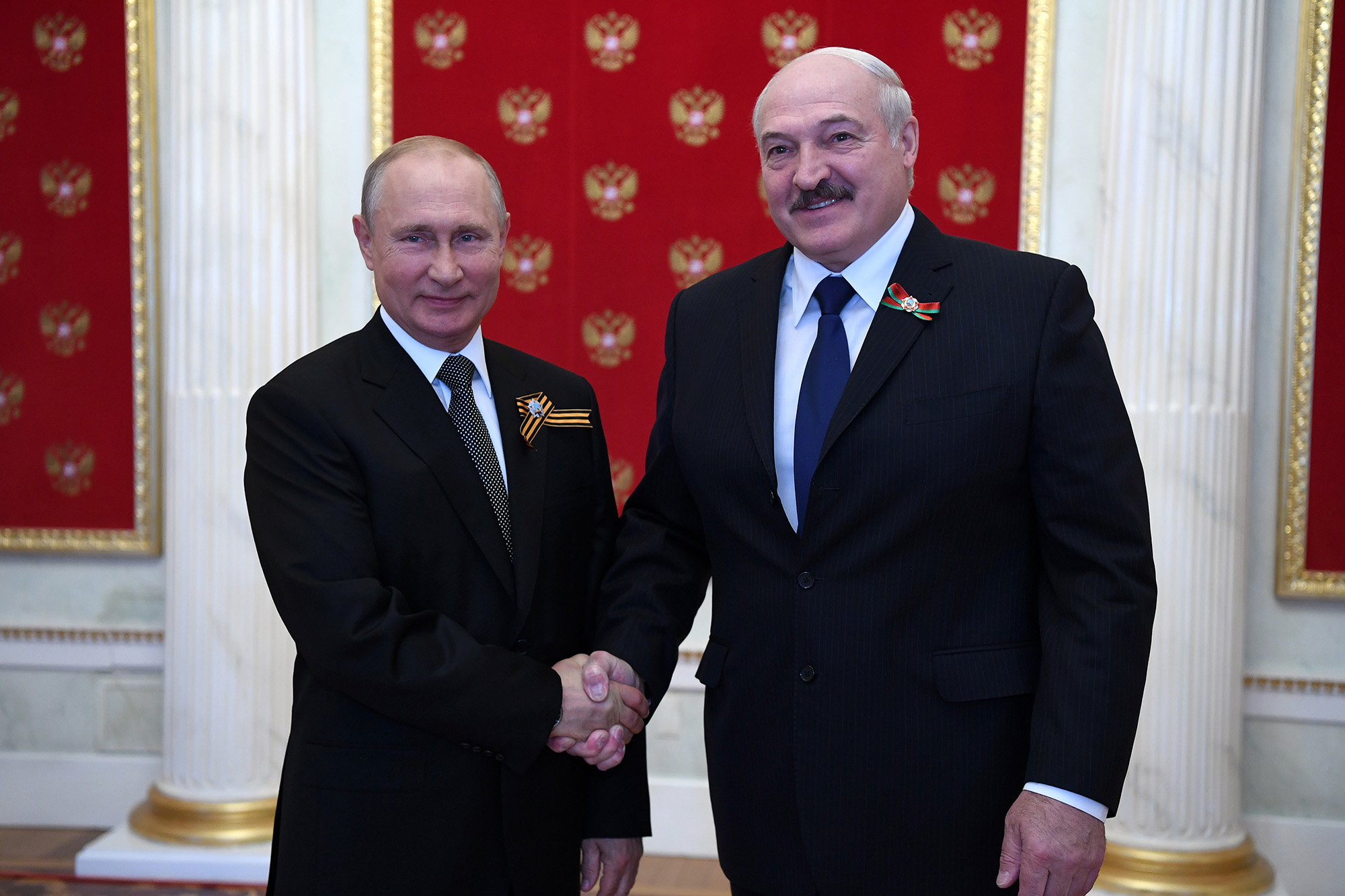 Russia's President Vladimir Putin (L) and Belarusian President Alexander Lukashenko shake hands as they pose for a photograph during a ceremony in the Kremlin, Moscow, Russia on June 24, 2020.