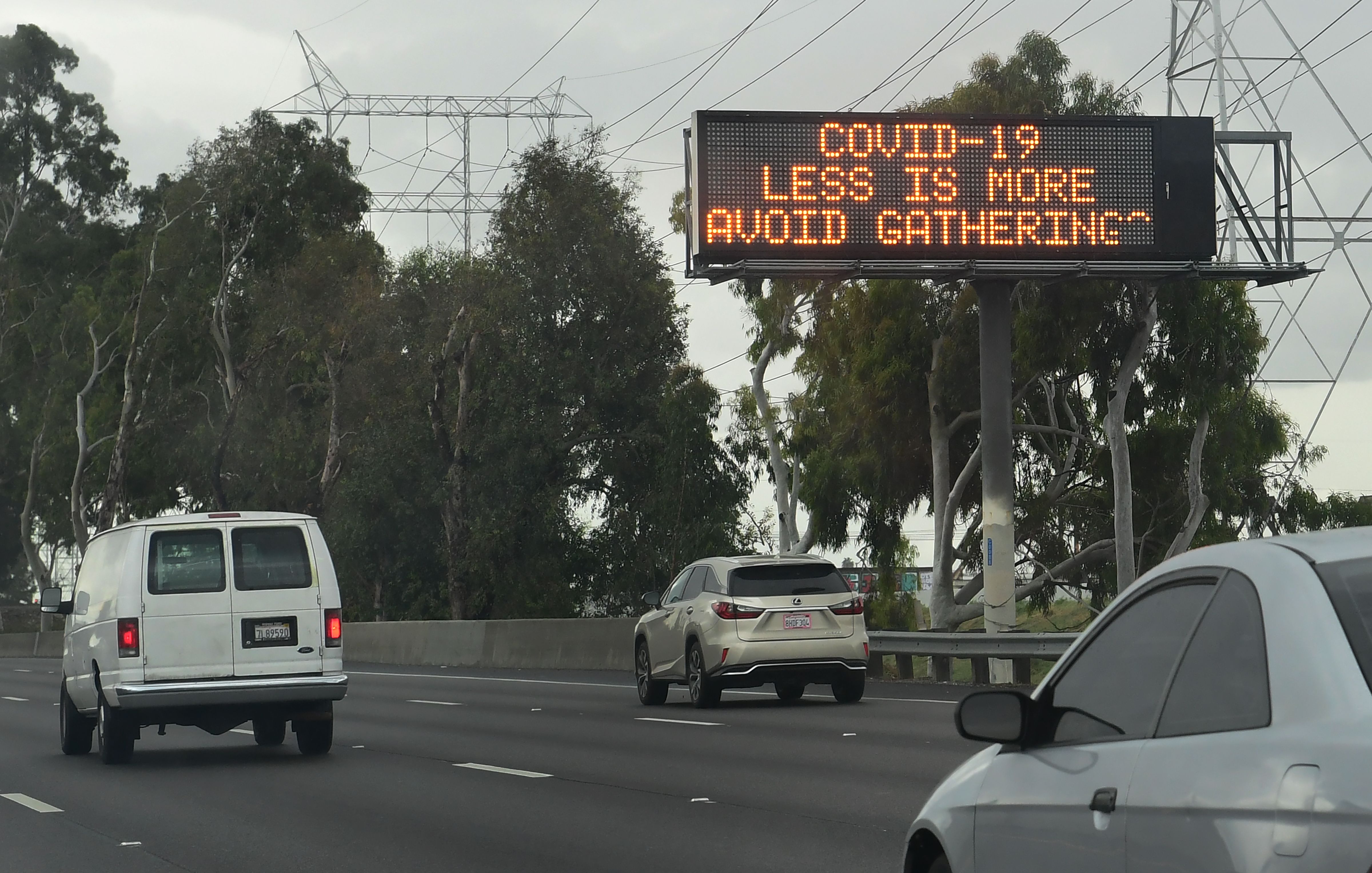 Motorists drive past a coronavirus traffic reminder on a southern California freeway on March 14, 2020 in Los Angeles.