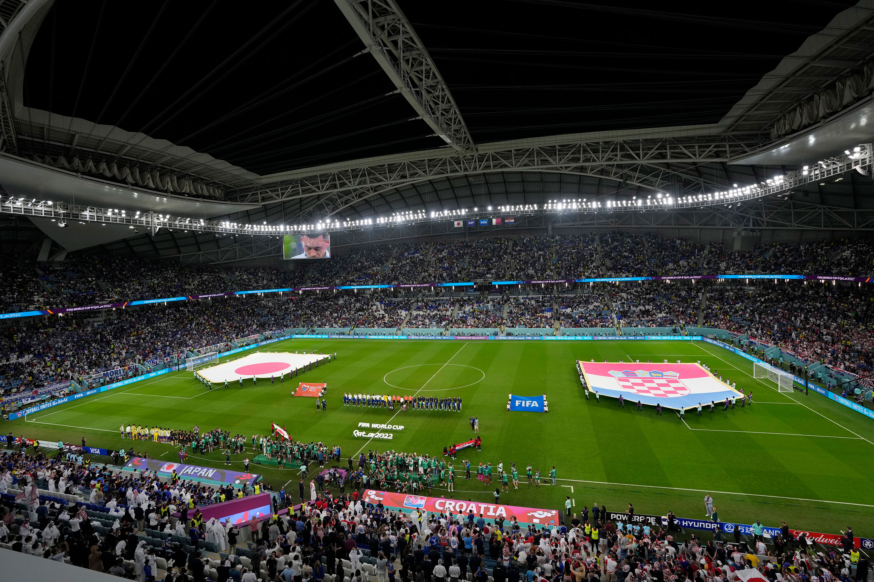 Teams line up before the match between Japan and Croatia on Monday.