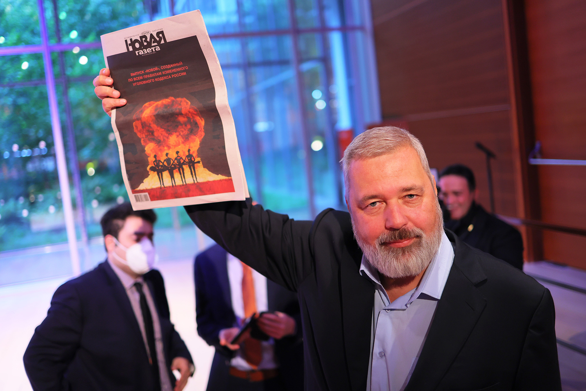 Nobel Peace Prize winner Dmitry Muratov, editor-in-chief of the Russian newspaper Novaya Gazeta, holds up a copy of his paper after the conclusion of bidding during a charity auction in New York on June 20, 2022.