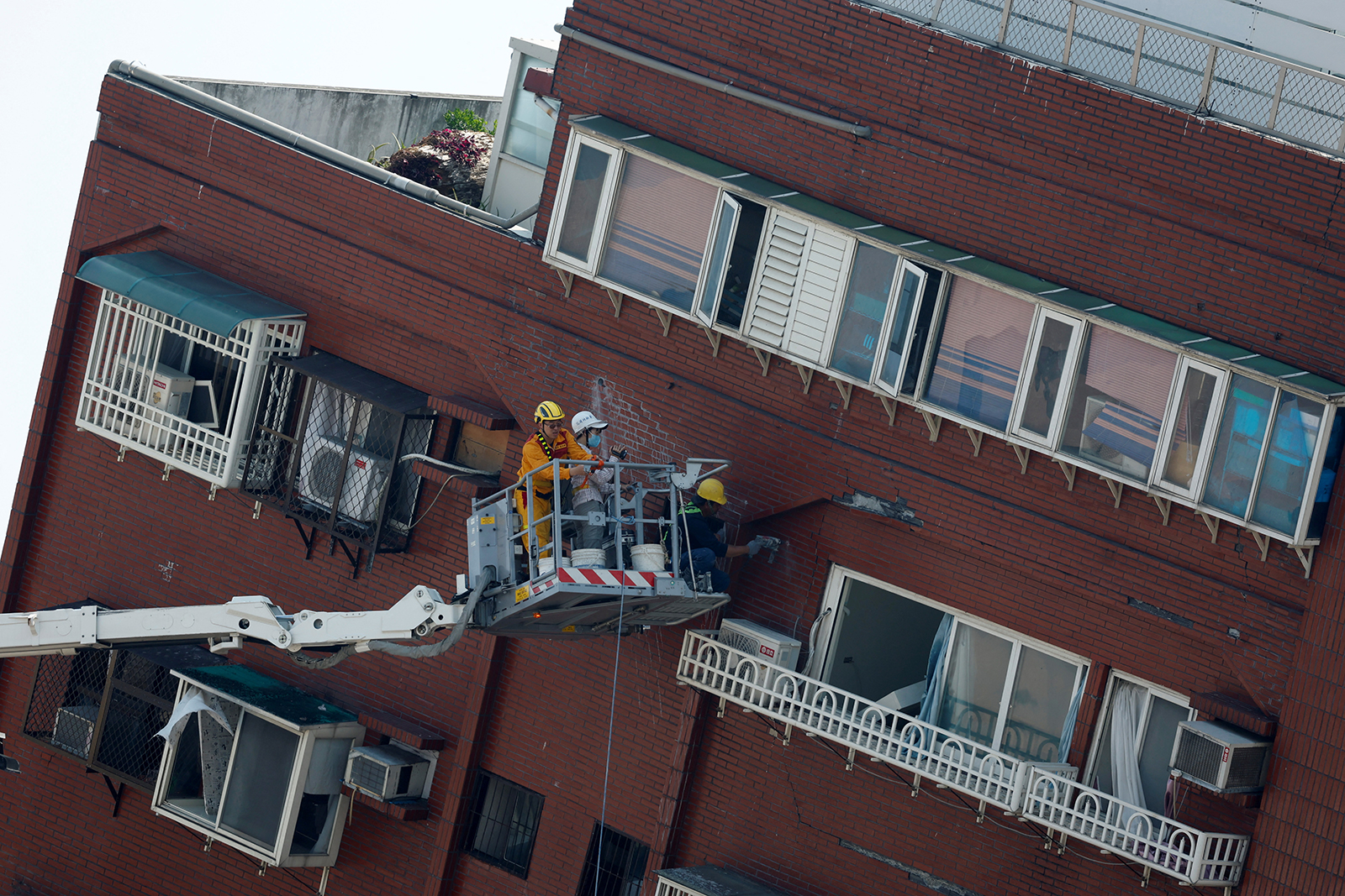 Workers carry out operations at the site where a building collapsed, following the earthquake, in Hualien, Taiwan on April 4.
