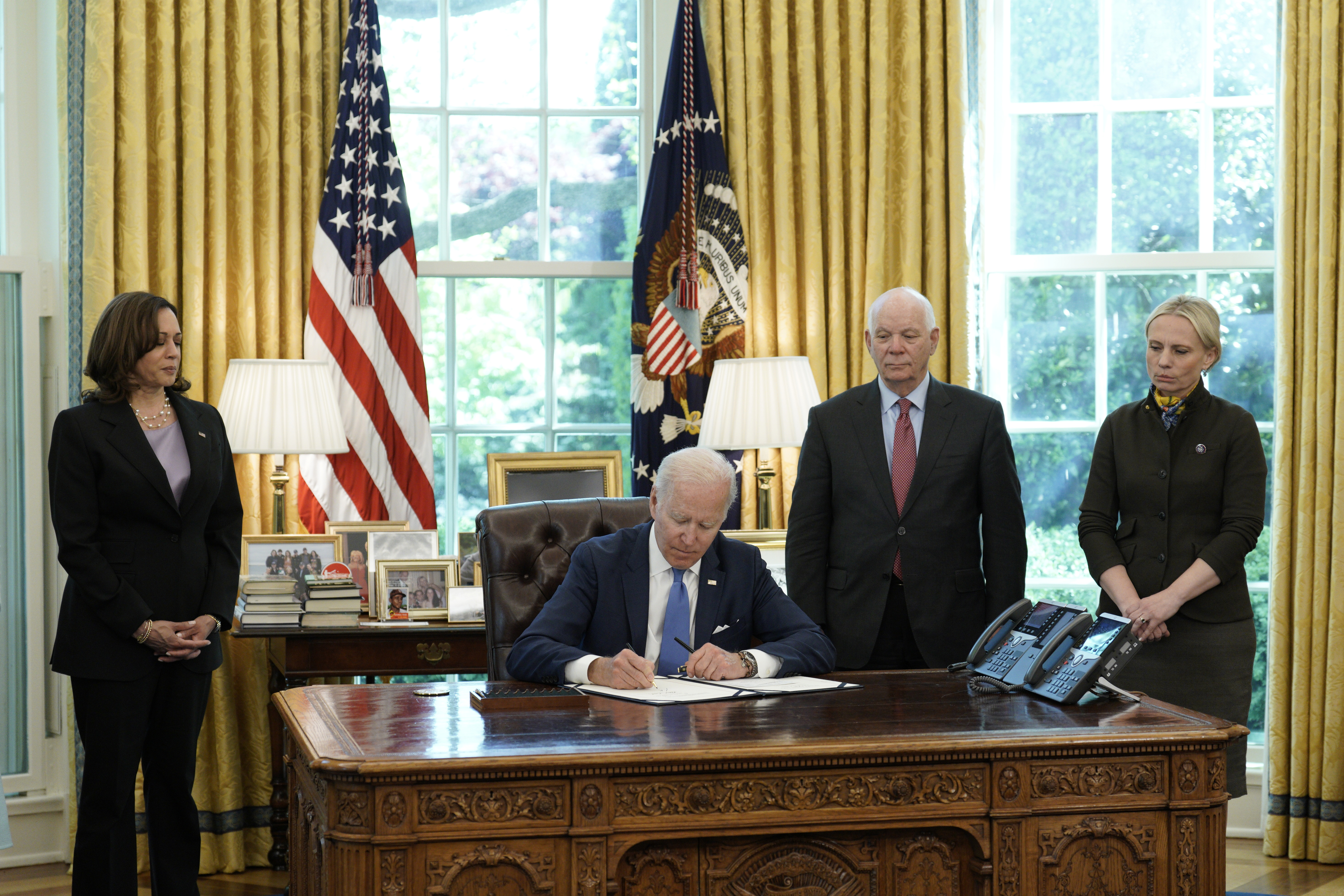 In the Oval Office of the White House, US President Joe Biden signs the "Ukraine Democracy Defense Lend-Lease Act of 2022," on Monday.